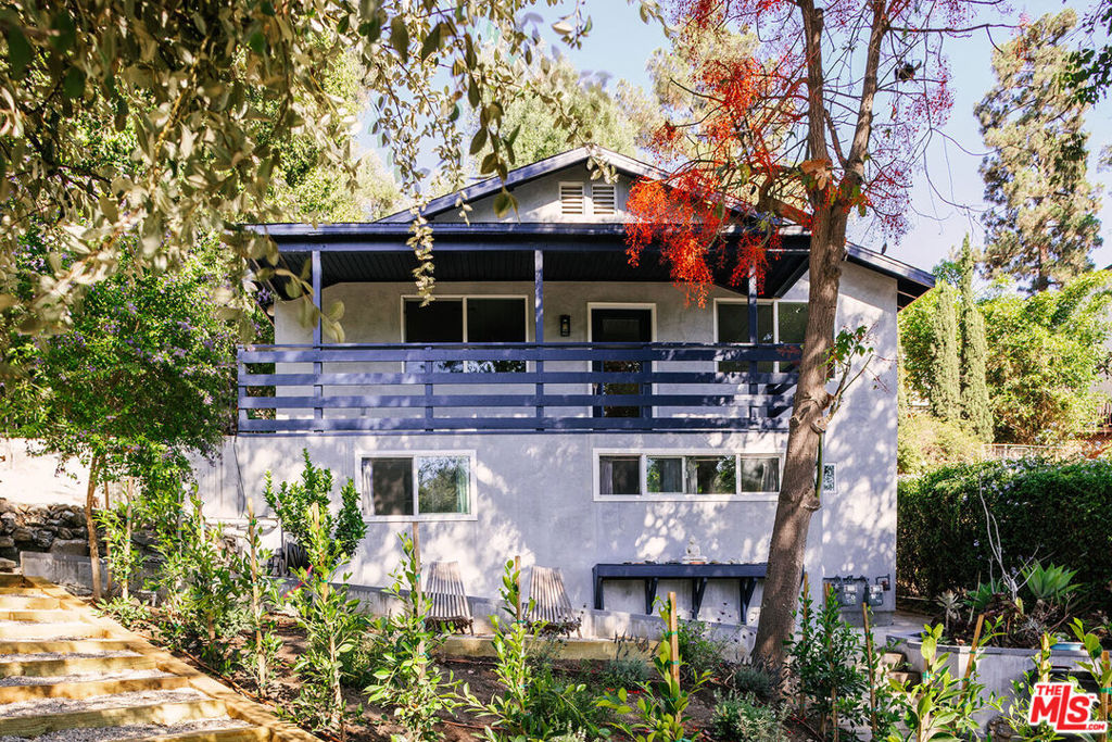 Tucked into the hills of Echo Park and set back from the street, this light-filled bungalow sits at the end of a private driveway, offering a sense of seclusion with lush surroundings and hillside views. The main residence has been thoughtfully updated and features two bedrooms and two bathrooms with a bright, open layout. Natural light pours into the living spaces, and the primary suite opens directly to the outdoors, creating a seamless indoor-outdoor connection. Step to the spacious deck, surrounded by mature landscaping, and unwind in the dry sauna or outdoor soaking tubyour own tranquil hideaway in the heart of the city. On the lower level, a detached studio with its own entrance, full bathroom, and kitchen provides flexible space for guests, a home office, or creative use. Located on a quiet hillside street just minutes from neighborhood favorites like Canyon Coffee, Cookbook Market, Bacetti, and the trails of Elysian Park. A rare opportunity to enjoy both privacy and proximity in one of LA's most vibrant neighborhoods.