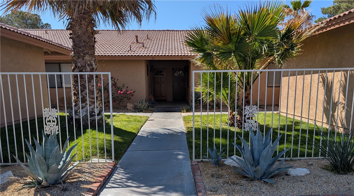 Extremely charming and well taken care of, this two-bedroom, two-bath condo sits right on the golf course. It features beautiful hardwood floors throughout and a tiled patio perfect for relaxing outdoors. The galley kitchen is very functional and right around the corner is the indoor laundry. This unit also has a two car garage. Recent updates include a new water heater and water pressure regulator, both replaced in 2023. The cold water lines have also been re-piped, offering peace of mind for years to come. Just move in and enjoy!!