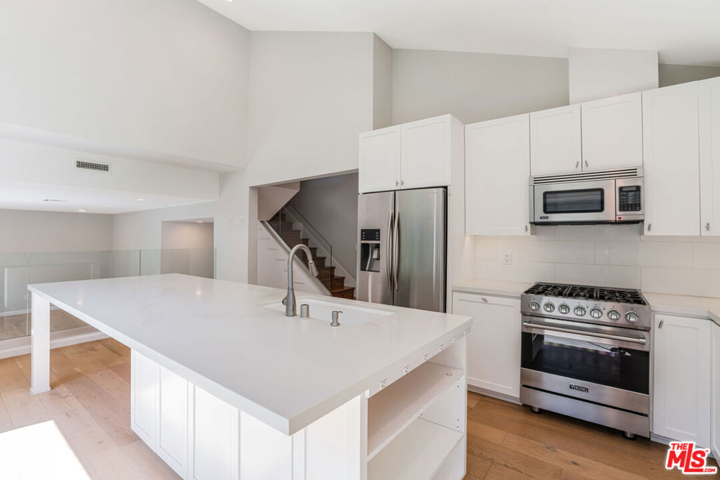 This stunning 2-story home has been thoughtfully updated throughout and offers comfort, space, and convenience in one of the Westside's most desirable areas. Step into a large living room with vaulted ceilings that flow seamlessly into an open-concept kitchen. The kitchen features an abundance of cabinet storage, a spacious island, and sleek stainless steel appliances. Just off the kitchen, the inviting family room includes sliding glass doors that open to a beautifully landscaped backyard complete with its own putting green - perfect for entertaining or relaxing outdoors. The home features four bedrooms and three full bathrooms, including one bedroom and a full bath on the first floor, ideal for guests or a home office. Upstairs, you'll find three more bedrooms, including a generously sized primary suite with an en-suite bathroom and ample room to unwind. There is a 2-car attached garage which also has a side-by-side washer and dryer. Located just moments from Ballona Creek Bike Path, Playa Vista, shops, restaurants, and so much more!
