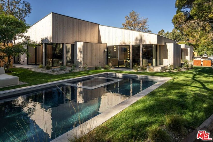 Completely reimagined post-and-beam home set on the only gated street in the exclusive Point Dume neighborhood of Malibu. Originally designed by renowned architect Ronald Goldman, FAIA in 1979, the home went through a meticulous 3-year "down-to the-studs" renovation by Alexander Design in collaboration with Alexander Built Properties. The 5-bedroom, 4-bathroom residence seamlessly blends the light filled warmth of post-and-beam architecture with modern luxury. The redesign honors Goldman's commitment to sustainability with drought-tolerant landscaping, cross-ventilation, and skylit hallways that flood the home with natural light. Inside, the home features custom cabinetry, millwork, and brass detailing by Alexander Design, alongside elegant custom stonework, door hardware, Fleetwood doors and windows, Gaggenau appliances, and Cocoon Piet Boom plumbing fixtures. Thoughtfully curated interiors include a blend of custom and collectible vintage furnishings that exude timeless sophistication. The latest and greatest amenities include a new saltwater pool, a pizza oven, a Sonos sound system, and heated bathroom floors. Nestled on a private cul-de-sac, the property also provides an access key to the exclusive Little Dume beach and a shared tennis court. This one-of-a-kind estate captures the essence of Malibu's effortless elegance, offering an unrivaled lifestyle of luxury and coastal serenity.