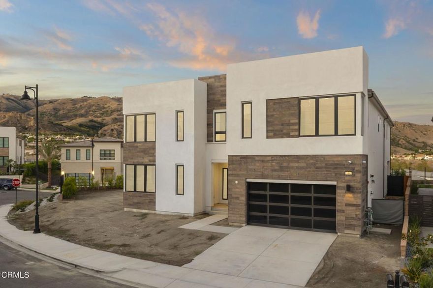 Modern Luxury in the Prestigious Westcliffe Guard-Gated Community!Experience architectural brilliance in this iconic Toll Brothers Santi Model Home, ideally positioned on a coveted corner. Stylish front tinted windows elevate the home's contemporary facade while offering enhanced privacy and modern appeal. This residence showcases 5 bedrooms, 5.5 bathrooms, and an open-concept design that embodies sophistication and seamless indoor-outdoor living. Every upgrade thoughtfully chosen, this home was designed with exceptional attention to detail and high-end finished throughout such as insulated flooring which helps minimize sounds between levels for added comfort.Step inside to soaring ceilings and floating stairs that set the tone for modern elegance. The gourmet kitchen is a chef's dream, featuring floor-to ceiling custom cabinetry, upgraded countertops and backsplash,  a waterfall-edge island, Wolf appliances, and Sub-Zero refrigerator, restoration hardware handles, a spacious walk-in pantry offers ample shelving for all your kitchen essentials and extra storage. The expansive great living room is bathed in natural light and framed by elevated upgraded windows and dramatic sliders that open to breathtaking city and mountain views. Upstairs, the primary retreat is a private sanctuary complete with its own living space, warm wood paneling adding texture with a spa-inspired bathroom featuring a rain shower head, Calacatta umber marble shower, and free standing soaking tub. Each secondary bedroom offers its own en-suite bath with upgraded mirrors, tile & countertops, and walk-in closets, ensuring every member of the family or guest enjoys privacy and comfort. Enjoy the upstairs loft perfectly positioned to take in the tall windows and stunning city and mountain views. Smart-home upgrades include remote-controlled window coverings, solar panels. Enjoy pre-wiring for in-wall speakers, outdoor TV, and fan, perfect for entertaining. The spacious tandem 3-car garage offers ample room for multiple vehicles, storage, or a home gym setup, ideal for those seeking flexibility and functionality.Located just moments from the Vineyards at Porter Ranch's premier shopping and dining, this home represents the pinnacle of California luxury living where every day feels like a five-star retreat.  Own a modern masterpiece of craftsmanship, design, and luxury.