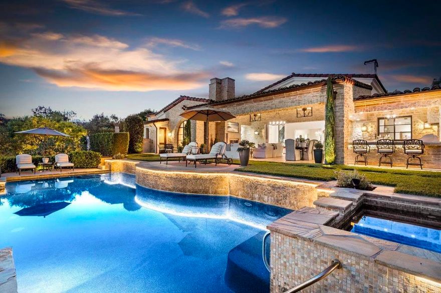 6320 Calle Ponte Bella is an exquisite single-story estate nestled in the exclusive gated community of The Bridges at Rancho Santa Fe. The home embodies the finest in Santa Barbara-inspired architecture and offers nearly 10,000 square feet of living space between the main home and the guest house. Situated on nearly 2 acres of usable land, this exclusive estate lot provides privacy, luxury, and breathtaking views of the 12th hole in one direction and unrivaled vistas in the others.  The home’s interior is a masterpiece of design, featuring elegant finishes such as travertine floors, wood beams, custom walnut cabinetry, and much more. The spacious floor plan includes a gourmet kitchen equipped with professional-grade appliances, a great room with lift and slide doors, creating seamless indoor-outdoor living, and multiple fireplaces, creating a warm, inviting atmosphere throughout. The master suite is especially noteworthy with a private terrace, luxurious spa bath, and extraordinary closet.  Outdoors, the property boasts a zero-edge saltwater pool, spa, outdoor kitchen, and expansive patios—perfect for entertaining guests or enjoying peaceful family time. The meticulously landscaped grounds also include a guest casita, bocce court, lush lawns, and classical gardens, creating a resort-like ambiance right at home.  Living in The Bridges comes with numerous perks. This prestigious community offers access (separate membership) to world-class amenities, including a championship golf course designed by Robert Trent Jones Jr., a private clubhouse with gourmet dining, fitness center, tennis courts, and a junior Olympic-sized swimming pool. Additionally, residents enjoy the security of 24-hour guard-gated entrances, ensuring privacy and peace of mind.
