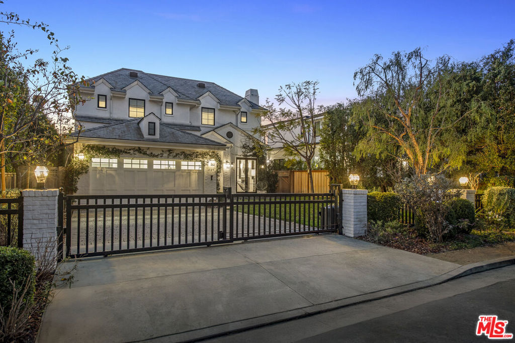 Set in a peaceful Brentwood enclave, this French Country-style residence effortlessly blends timeless style with modern convenience. Beyond gates, the home unfolds across 5,619 square feet of light-filled living space showcasing premium finishes like herringbone wood floors, built-ins, and state-of-the-art Control4 home automation. Chic, understated interiors provide the ideal backdrop for everyday living or entertaining, with multiple living rooms, a stunning gourmet kitchen, a dining room, and seamless transitions to the backyard. The jewel of the home is the kitchen with gorgeous marble slab stone countertops and backsplash, professional grade appliances including a Wolf double-oven range and double dishwashers, and ample pantry storage. Enjoy the versatility of six spacious ensuite bedrooms, inclusive of the grand primary suite with high vaulted ceilings, a private balcony, two walk-in closets, and an awe-inspiring spa bathroom with steam shower, soaking tub, and separate make-up vanity. Descend to the lower level to find a home theater with a wet bar -- great for movie night, watching the big game, and more -- two ensuite bedrooms with walk-out patios, and a laundry room with dual washer/dryers. Revel in endless California sunshine from the generous backyard enveloped in tall hedging for total tranquility. Here, a stone patio provides a covered area anchored by an exterior fireplace with heaters and a TV, and an uncovered area with a built-in outdoor kitchen. Just beyond is a green lawn and a sparkling pool and spa behind glass safety fencing. Other notable features include the convenient mud room and powder room on the main level, interior/exterior surround sound, an automatic driveway gate with pedestrian gate, and parking for four vehicles in the driveway and attached 2-car garage. Experience the best of Westside living with moments-away access to the area's finest restaurants, boutiques, and popular hot spots like Brentwood Country Mart, Brentwood Country Club, and just a few short miles to the coast.