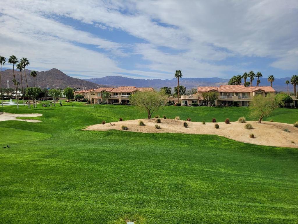 This upper-level property is located close to the Palm Royale Country Club Clubhouse, tennis and pickleball courts. The balcony offers views of the fairways and local mountain ranges. Interior features a great room floor plan with vaulted ceilings. The kitchen offers newer appliances and is open to the main living area. Decorated in warm neutral colors and offered furnished. With energy-efficient vinyl doors and windows the property combines luxury with sustainability. The shutters offer privacy and style. The inclusion of a 1-car garage adds practicality to the package. The complex's amenities include 6 community pools and spa areas, to provide ample opportunities for relaxation and recreation. The added perk of UNLIMITED golf on a Ted Robinson designed par 3 course. Featuring tennis and pickleball courts that are well maintained. Now the area headquarters for Helix Disc Golf, enhances the lifestyle appeal. Low HOA dues covering essential services, cable, and internet make for worry-free living, while convenient access to shopping, dining, and transportation adds to the property's allure. Situated across from the Indian Wells Tennis Gardens, home of the Paribas Open, this property is perfect for either full-time residence or a luxury seasonal home. Overall, it truly offers a lifestyle of convenience and luxury, appealing to those seeking the ultimate in comfort and relaxation.