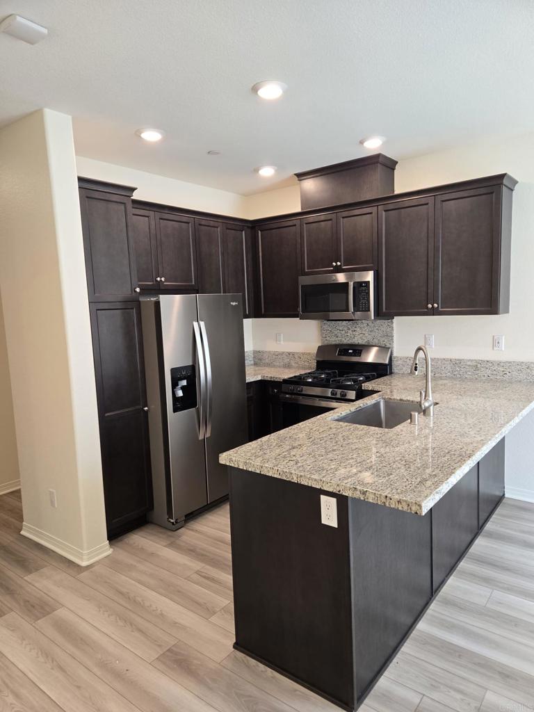 Welcome to this freshly painted home in the desirable gated community of Village Walk. This bright and spacious residence offers an open floor plan with plenty of natural light. The living area flows seamlessly into the kitchen and dining space, creating a comfortable layout for daily living and entertaining. Enjoy two generously sized bedrooms, including a primary suite with ample closet space and a private bathroom. Additional highlights include in-unit laundry, central heating and air conditioning, and a private balcony perfect for relaxing outdoors. The community features resort-style amenities including a pool, spa, fitness center, and beautifully maintained grounds. Conveniently located near shopping, dining, schools, and easy freeway access, this home is move-in ready and available now.