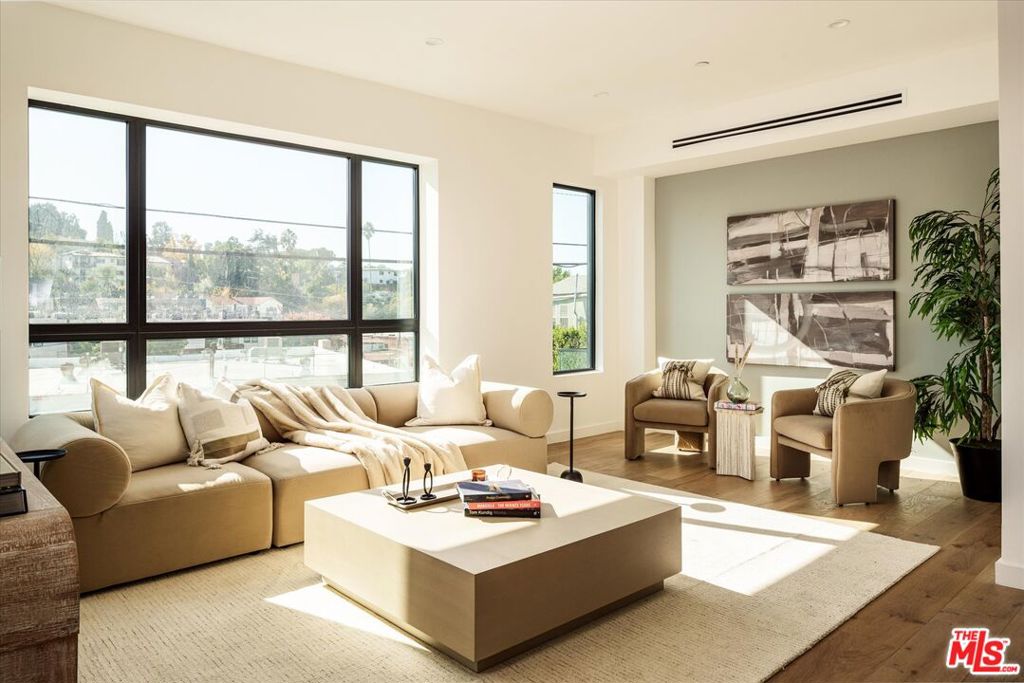 Located just steps from Ivanhoe Elementary, Griffith Park, and the vibrant corridor of Hyperion Avenue is The Selene, a newly developed collection of five exclusive luxury residences offering style, sophistication, and understated luxury in one of Los Angeles' most convenient neighborhoods. 2824 1/2 Avenel is a coveted corner residence with a sun-drenched, open-concept floor plan and modern interiors that exude warmth. An expansive great room serves as the home's focal point for entertaining, with high ceilings, large window spans, and dedicated indoor-outdoor spaces for lounging and dining. The sleek kitchen is a perfect fusion of design and practicality, showcasing a generous eat-in island, ample white oak cabinetry, and a suite of high-end luxury appliances. The spacious primary offers a serene retreat with southern-facing views, a private Juliette balcony, a custom walk-in closet with white oak shelving, and a spa-inspired bath featuring dual vanities and a wet room with a freestanding tub. Two additional ensuite bedrooms complete the living arrangements. A large rooftop deck with panoramic views of the hills provides a retreat for relaxing in the sun or hosting a soiree. Additional features include a small dog run with artificial turf, a direct-entry 2-car garage, owned solar panels, and a convenient full-size laundry closet on the bedroom level. Just a short a commute to Downtown LA and Hollywood and within minutes from the shops and restaurants at Sunset Junction, Atwater Village, and Hillhurst Avenue.