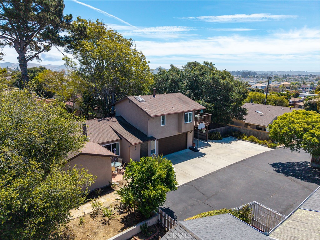 This turnkey 3-bedroom, 3-bathroom home offers approximately 1,702 +/ square feet of living space on an 8,743 +/- square foot private flag lot in desirable North Grover Beach. Thoughtfully updated, the home features two primary suites—including an upstairs retreat with a wood-burning heater, a cozy bay window sitting area, and a deck with peekaboo ocean views. The wrap-around new trex deck spans the side and back of the home, perfect for entertaining or relaxing in the coastal breeze. Recent improvements include new windows and sliding doors, laminate flooring, ceiling fans in every room, an updated full bath insert, gutters, and a cooling center for added comfort. The home is equipped with a wall furnace for heating. Two bedrooms are located on the main level, with a private upstairs suite offering added flexibility. Zoned R2 and conveniently located near beaches, parks, shopping, and dining, this coastal gem is a rare find on the Central Coast. Schedule your showing today!