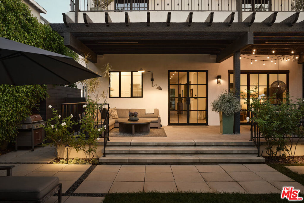 A timeless, light-filled Contemporary Spanish retreat has been meticulously reimagined in the heart of the West Hollywood West Design District. This residence seamlessly blends the classic charm of the 1920s with the refined comforts of modern luxury. Upon entering through steel and glass doors, guests are welcomed into a warm formal living room, followed by a generous dining area. The thoughtful chef's kitchen opens into an airy family room and wine bar, creating an inviting atmosphere for both relaxation and entertaining. Additionally, a guest suite, currently styled as a home office, offers flexibility for work or visitors. Step outside to experience quintessential California indoor/outdoor living, where lush front and rear gardens frame vacation-like scenery. The grounds feature two citrus trees, an avocado tree, a soothing hot tub, and a sparkling swimming pool-perfect for unwinding or gathering with friends. Upstairs, three bedrooms and three bathrooms provide comfortable accommodations. The expansive primary suite has been thoughtfully designed to evoke the ambiance of a luxury resort. Featuring a spa-inspired bathroom, a spacious walk-in closet, and a private terrace, this sanctuary is perfect for enjoying peaceful mornings with a cup of coffee in the sun. Every detail has been carefully considered to ensure comfort and elegance, creating a true retreat within the home. Throughout the home, best-in-class finishes, and timeless details cater to the most discerning tastes. Additional features include Leviton lighting system, Control4 door station and audio system, security cameras, outdoor heaters, motorized driveway gate, Kasa smart outlets, Halo whole home filtered water, and built in indoor and outdoor speakers. The property offers an idyllic escape on one of West Hollywood's most sought-after streets, distinguished by its rare blend of privacy and proximity to celebrated restaurants, boutiques, and lifestyle amenities.