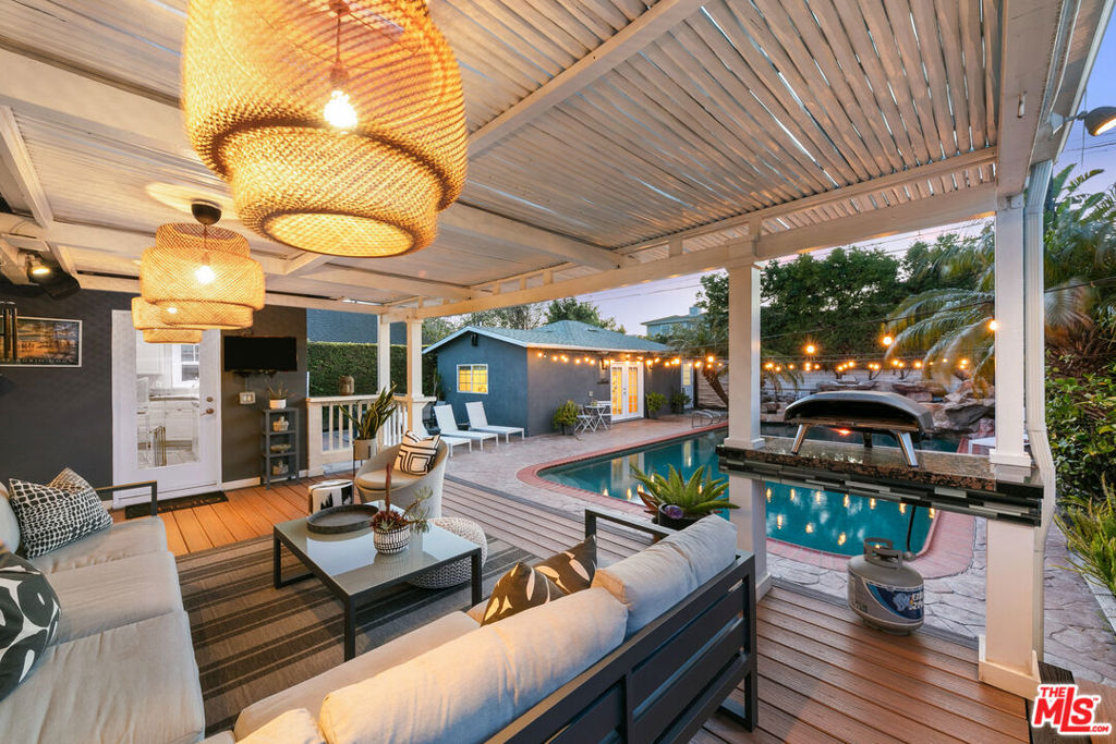 Discover the perfect fusion of luxury, comfort, and entertainment in this stunning Westchester home, nestled on a picturesque tree-lined street in the highly sought-after Kentwood neighborhood. Designed for seamless indoor-outdoor living, this private oasis is a rare gem. Step inside the smart home-enabled main residence, where an expansive open-concept living area, dedicated dining space, and a generously sized kitchen with newer appliances create an inviting atmosphere for both relaxation and hosting. Featuring three spacious bedrooms and two updated bathrooms, this home offers the perfect blend of style and functionality. Additionally, enjoy the advantages of the fully owned solar panels, ensuring energy efficiency and lower utility costs. Outside, your resort-style retreat awaits. A Pebble Tec, saltwater pool with a waterslide and a cascading waterfall hot tub sets the stage for endless fun and relaxation. A spacious covered deck with a fully equipped outdoor kitchen makes al fresco dining and entertaining effortless year-round. Enhancing both value and versatility, the detached ADU boasts its own address, one bedroom, one bathroom, a full kitchen, and a private entrance ideal for rental income, accommodating guests, or creating the ultimate home office. A separate outdoor bathroom with a steam shower provides added convenience for poolside entertaining. Centrally located just minutes from pristine beaches, top-tier dining, and premier entertainment, this home embodies the essence of California living!