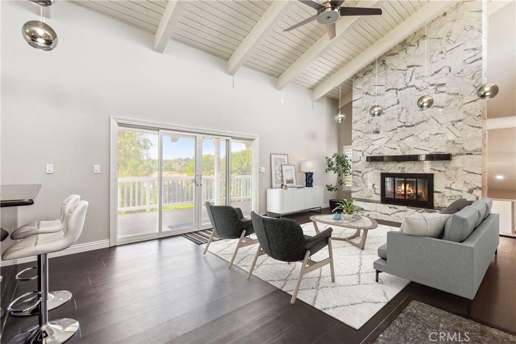 Welcome home to "The Country" Estates, this prestigious and highly sought-after community in Diamond Bar offers 24-hour guard gated entry with Resort-like amenities including clubhouse, heated swimming pool, tennis courts, banquet facilities and more. The impressive, split level, custom home boasts 4 bedrooms, 3 bathrooms, with 3,082 sq ft of living space and sits on a large private 0.79 Acre premium lot featuring excellent curb appeal with brick exterior accents, unobstructed panoramic views, turf, and drought-tolerant landscaping! The interior offers marble and new vinyl plank floors, fresh paint, new light fixtures, new hardware, new HVAC, plantation shutters, custom baseboards, recessed lights, and you'll also find decks on all 3 levels with new railings. The main level features an open kitchen equipped with a work station, custom white cabinetry, black granite countertops, 2 islands, skylights, stainless steel appliances and opens to the stunning family room with vaulted beamed ceilings, floor to ceiling marble fireplace feature wall, pendant lighting on either side of the room a built in wet bar with seating area, and double slider to the attached deck - this is truly an entertainer's dream space. Just off of the main entry is also a formal dining room with a modern chandelier and across the main entry take a short staircase down to the formal living room also with beautiful vaulted beamed ceilings as well as a fireplace. A door from the kitchen provides direct access to the spacious 3-car finished garage, complete with epoxy flooring, a workbench, and extra storage space. Off the formal living room, you'll be greeted with the Primary Suite, which includes 2 mirrored closets as well as a large walk-in closet and private balcony. The Primary Bathroom features dual vessel sinks, a jet tub, a separate shower, and mosaic inlay accents. The bottom floor also includes a generously sized bonus flex room that could serve as a home theater, gym, or game room that also features a wet-bar with bar seating, built-in wine storage, modern chandelier, and large storage closet. There is also a slider to a private attached deck. The bottom floor boasts 3 more secondary bedrooms and a bathroom. Also, enjoy the backyard with ample space for a pool and endless possibilities for your own customization. Don't miss this opportunity to own a home within The Country (Diamond Bar Country Estates)!