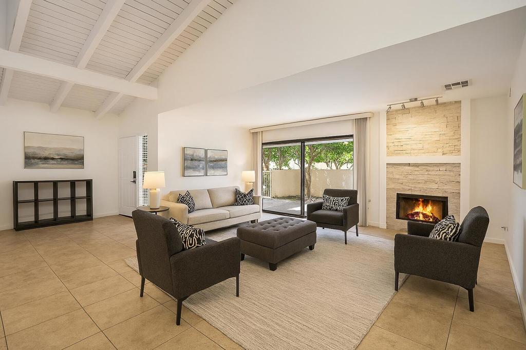 In the heart of South Palm Springs, this 2-bedroom, 2.5 bathroom ground-level condominium offers 1,568 Sq. Ft. on fee land; You own the land. Positioned with no one above, this residence enjoys a prime location within the complex and features five separate patios, connecting indoor comfort to outdoor serenity. Vaulted ceilings, clerestory windows, walls of glass, expansive living area, stack-stone fireplace and tile flooring throughout. Two spacious primary bedrooms each feature walk-in closets, and updated en-suite bathrooms. The kitchen is appointed with newer stainless appliances, down lighting, and connects to a breakfast area plus a separate formal dining room. A dedicated bar with built-in sink. Notable upgrades include a newly installed rooftop HVAC (2025), ensuring quiet, efficient climate control. Bathrooms have been updated with quartz countertops, modern sinks, and LED lighting. Interior washer and dryer adds convenience. Residents enjoy a full suite of HOA amenities including four pools and spas, lighted tennis courts, lush landscaping, roof and exterior maintenance, earthquake insurance, water, trash, and sewer services. Deeded covered parking and ample guest parking complete the offering. Located across from Smoke Tree Shopping Center and just minutes from downtown Palm Springs, this home places you moments from world-class dining, boutique shopping, a renowned Casino, and so much more. Don't miss the opportunity to own this desirable condo and experience the vibrant lifestyle of Palm Springs!