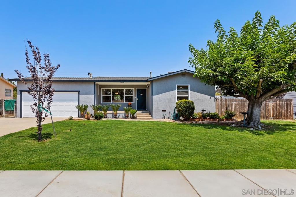 Nestled in the heart of Bostonia, this meticulously maintained original owner mid-century cottage sits on an expansive, flat 1/4 acre lot (11,300 sq. ft lot), offering a rare combination of charm, functionality, and future potential. A welcoming front porch overlooks a lush, manicured lawn framed by a stately shade tree, setting the stage for the warmth and character found within. Inside, the beautifully remodeled kitchen blends vintage allure and modern elegance, featuring a classic chrome-top O’Keefe & Merritt stove, sleek quartz countertops, and generous cabinetry. The open floor plan invites easy living, seamlessly connecting to the outdoors for year-round enjoyment. Step outside to discover a private backyard retreat designed for relaxation and entertainment, complete with a spacious wood deck, a 12x14 gazebo with solar lighting, a Kevlar-reinforced sunken above-ground pool, and new low-maintenance turf surrounded by mature fruit and shade trees. The expansive lot offers gated side access—ideal for RVs, boats, or off-road vehicles—and presents an excellent opportunity for a future guest house or ADU. Additional highlights include quality craftsmanship, central A/C, fresh interior and exterior paint, a two-car garage with built-in cabinetry, extra outbuildings, and an automated sprinkler system. Perfectly situated with walkable access to shops and dining, and just minutes from schools, parks, and freeways, this property is a rare find with timeless appeal and limitless possibilities.