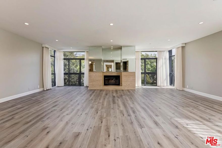 Contemporary condominium located on a beautiful, tree-lined street north of Burton Way in prestigious Beverly Hills. This updated 3 bedroom, 2.5 bath unit is filled with natural light and accessed through a dramatic black and white tiled formal entry with a private elevator. Thoughtfully designed, the unit features mirrored walls, floor-to-ceiling windows, and a combination of hardwood and marble floors. The expansive living room offers high ceilings, serene treetop views, a large balcony, a wet bar, and a fireplace. The designer kitchen includes a breakfast area, marble countertops and backsplash, dual ovens, a direct trash chute, and stainless steel appliances. A large bonus room maybe used as an office. The spacious primary suite features a fireplace, extensive cabinetry, walk-in cedar closets, and a built-in vanity. The en-suite primary bath includes a separate marble shower, a spa tub, and double sinks. The property offers three secure subterranean parking spaces. Available February 2026. By appointment only. No sign on the property.