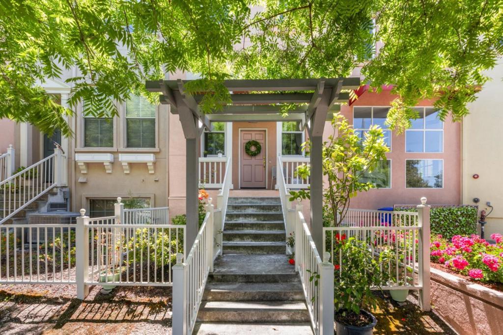 Discover a beautiful two-bedroom townhouse nestled in the highly sought-after Crossings Community, ideally located at the intersection of Palo Alto, Mountain View, and Los Altos. This property is near the major high-tech companies, and within walking distance to the Village at San Antonio Center. Ideal for remote work or commuting, this home is within the boundaries of the highly regarded Los Altos Schools (Covington Elementary, Egan Middle, Los Altos High; buyers to verify). The freshly painted interior features beautiful Brazilian Cherrywood flooring throughout the living area. The primary bedroom boasts a soaring vaulted ceiling, a walk-in closet, and a spacious bathroom with a double sink vanity. Additional perks include a whole wall of closets in the garage for extra storage, an electric vehicle (EV) charger, and low HOA fees. Community amenities include pools, a spa, a clubhouse, and playgrounds. Don't miss the chance to own this prime property in Mountain View, conveniently close to all the city's offerings!