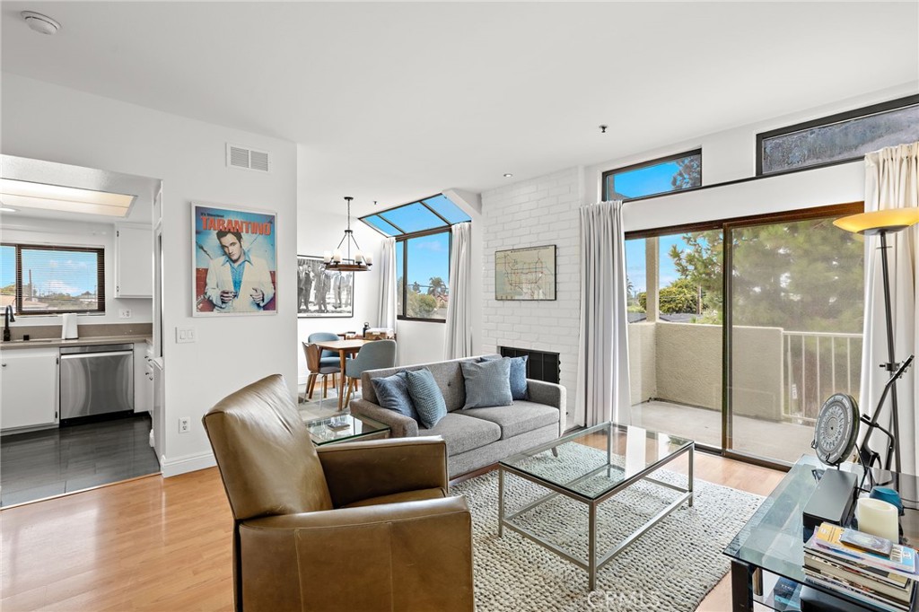 END UNIT WITH ENDLESS UPGRADES AND NEWLY ADDED CENTRAL A/C. This upstairs condo is the largest floorplan in the Brookstone community. The open layout boasts a gas fireplace, high ceilings, skylights and an abundance of natural light. An upgraded kitchen includes stainless steel appliances, quartz countertops, recessed lighting, a breakfast bar and your own in-unit stackable washer and dryer. The large primary bedroom has dual mirrored sliding glass closet doors and a newly remodeled ensuite primary bathroom. The secondary bedroom, with adjacent remodeled bathroom, also includes a window seat and huge walk-in closet. Large sliding glass doors from the living room and primary bedroom open to a spacious balcony with greenbelt views and a private storage closet. The unit comes with its own enclosed detached garage, an assigned parking space right out front, as well as guest parking spaces directly across the parking lot. Other upgrades include laminate wood flooring, new interior paint, ceiling fans, light fixtures, plumbing fixtures and a front door smart lock. The HOA offers amenities such as a pool, spa, internet, basic cable and trash service. Come quick! This turn-key condo won't last!!!
