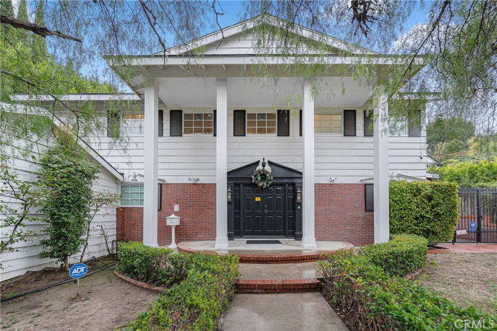 Situated in the heart of Studio City, this beautifully renovated two-story Colonial home offers timeless charm and modern luxury. The inviting exterior is framed by lush landscaping, complemented by a spacious two-car garage. Fully updated in 2016, the home features a new roof, windows, and doors, ensuring both style and durability. Step through the elegant double-door entry into a bright and airy floor plan spanning 3,077 square feet, complete with five bedrooms and four bathrooms. The interior showcases exquisite hardwood floors, high ceilings, recessed lighting, crown moldings, and built-in shelving, creating a warm yet sophisticated ambiance. The grand formal living room, with its cozy fireplace and two bay windows, is bathed in natural light, making it a perfect space to unwind. Designed for culinary enthusiasts, the gourmet kitchen is equipped with top-tier appliances, stunning marble countertops, a central island, and elegant shaker-style wood cabinetry. Each bathroom is tastefully appointed with modern finishes, while the spacious bedrooms offer an abundance of natural light. The primary suite serves as a private retreat, featuring a charming brick fireplace, a luxurious ensuite bathroom with a double vanity, a walk-in shower, and a relaxing soaking tub. Outside, the backyard is an entertainer’s dream, boasting a sparkling pool with a new filter and ample green space for outdoor enjoyment. A covered patio provides the perfect spot for gatherings, offering both comfort and privacy. The property sits on a mostly leveled lot, maximizing the usability of the outdoor space for relaxation and entertainment. The home has also been upgraded to meet the latest earthquake safety standards, with new drywall, electrical systems, plumbing, and drainage. Conveniently located with easy access to Mulholland Drive and Laurel Canyon Blvd, the home is just minutes from the Laurel Canyon Dog Park, Fryman Canyon Park, and the scenic Fryman Trail. This exceptional Studio City residence offers the perfect blend of elegance, comfort, and prime location.
