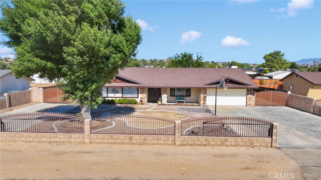 Located near Rio Vista School. Enjoy being just a few minutes drive to major retailers, grocery, services, and home improvement as well as theater and big box shopping. This location is highly sought after with Yucca Loma/Nisqualli direct access to the I-15. This home is built on a large lot with drive through access on BOTH sides of the home. Enjoy roaming and playing on your large fully fenced lot with brick and wrought iron fencing, dual rolling gates, and extended parking. Perfect for parking several vehicles, or for bikes and scooters! The back yard is wonderful with storage sheds, large covered patio, and mature shade tree. The interior of this home has been updated. The kitchen room sits between a large living room, and a large family room with fireplace. Note that the dining room can accommodate a China hutch in addition to the table seating. Kitchen has lots of counter space with space for food prep and buffet service when you entertain. All bedrooms are oversized. Kitchen features new faucet, updated lighting, granite counters, and stainless steel appliances. Landscape in the front adheres to water wise use, with rock and curbing added. Lovely planters greet you at the front walk way. Double door entry. Don’t miss the bonus room which is in additional square footage on top of the house footage. This room is open to interpretation: play room, office space, guest space, hobby room, game room, media room….the possibilities are endless.
