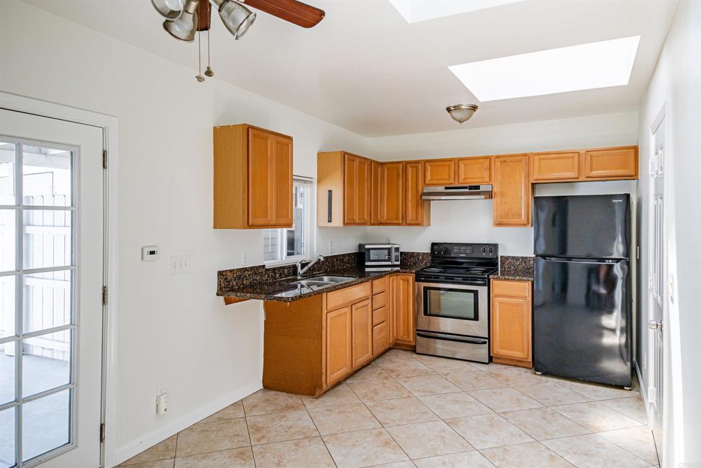 Your own cozy, private retreat. This light and bright one-bedroom house offers comfort, convenience, and privacy—perfectly tucked away on the back half of a two-unit property. The freshly painted exterior adds great curb appeal, and inside you’ll find laminate and tile floors, an updated eat-in kitchen with granite countertops, and plenty of natural light throughout. Enjoy direct access from your ATTACHED garage into the home, plus a private patio ideal for relaxing or entertaining. The laundry facilities provide added convenience. This well-maintained home is move-in ready and offers a quiet residential setting with modern updates and easy accessibility. Shared Washer and dryer included. Private entry off the alley. Owner is a licensed real estate agent.
