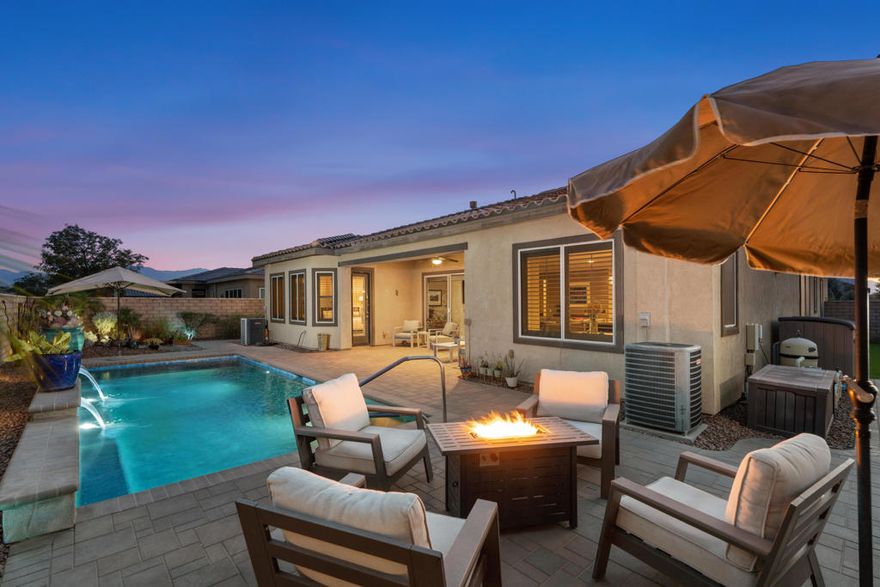 Experience desert living at its finest in this upgraded 3-bedroom, 2.5-bath, 2,536 SF residence, complete with an attached two-room casita. Situated on a corner lot, the home features striking curb appeal and expanded outdoor living space that blends style and functionality. The Great room boasts a custom fireplace, crown molding, LED recessed lighting, and solar shades for energy efficiency. Panoramic sliding doors create a seamless indoor-outdoor environment, leading to a private backyard oasis with a sparkling salt-water pool including Baja shelf, sheer descent waterfalls, and low-maintenance landscaping--ideal for entertaining or relaxation. The chef's kitchen includes custom cabinetry, granite counters, stainless appliances, an oversized island, and a spacious pantry. Thoughtful details enhance livability, such as direct access from the primary bedroom's walk-in closet to the laundry room, which also features an additional walk-in pantry/linen closet. Plantation shutters throughout and retractable screen doors offer convenience and luxury. The 2-car plus golf cart garage provides extra storage for active lifestyles. Located in Four Seasons at Terra Lago, a vibrant 55+ community with a resort-style clubhouse, pools, fitness center, and numerous events, this home offers unmatched luxury and location, close to dining, shopping, and entertainment. Schedule your private showing today!