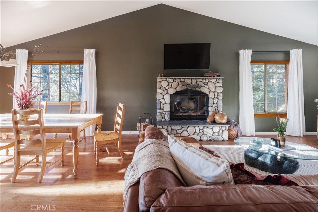 This beautifully maintained 4-bedroom, 3.5-bath home is tucked away on a quiet, low-traffic street a stones throw from from Tavern Bay Beach Club, and only 10 minutes by car from the Village. Backing directly to National Forest land, the property offers unmatched privacy and views. From the back decks, take in sweeping sunsets over the trees and distant hills, and enjoy peaceful evenings gathered around the fire pit on the oversized front porch.
Inside, the home offers level entry and a spacious open-concept main floor, perfect for entertaining with two living areas and separate dining. The updated kitchen features a breakfast bar and new appliances, while updated flooring, fresh paint, and three fireplaces add warmth and character throughout. On the middle floor, a primary suite with walk-in closet, renovated bathroom and romantic fireplace, plus two more bedrooms. The lowest level offers a 4th bedroom and large game room plus bathroom and laundry, giving guests young and old their own space to play and unwind.
The home comes fully furnished and includes a newer roof, generous storage in the attached 2 car garage, and lovely outdoor spaces galore. Whether you're looking for a full-time residence or a weekend retreat, this is the kind of home that’s been deeply loved—and it shows. With lake rights and the forest as your backyard, it’s ready for you to start your next chapter. And yes, it has an active short-term rental permit!
