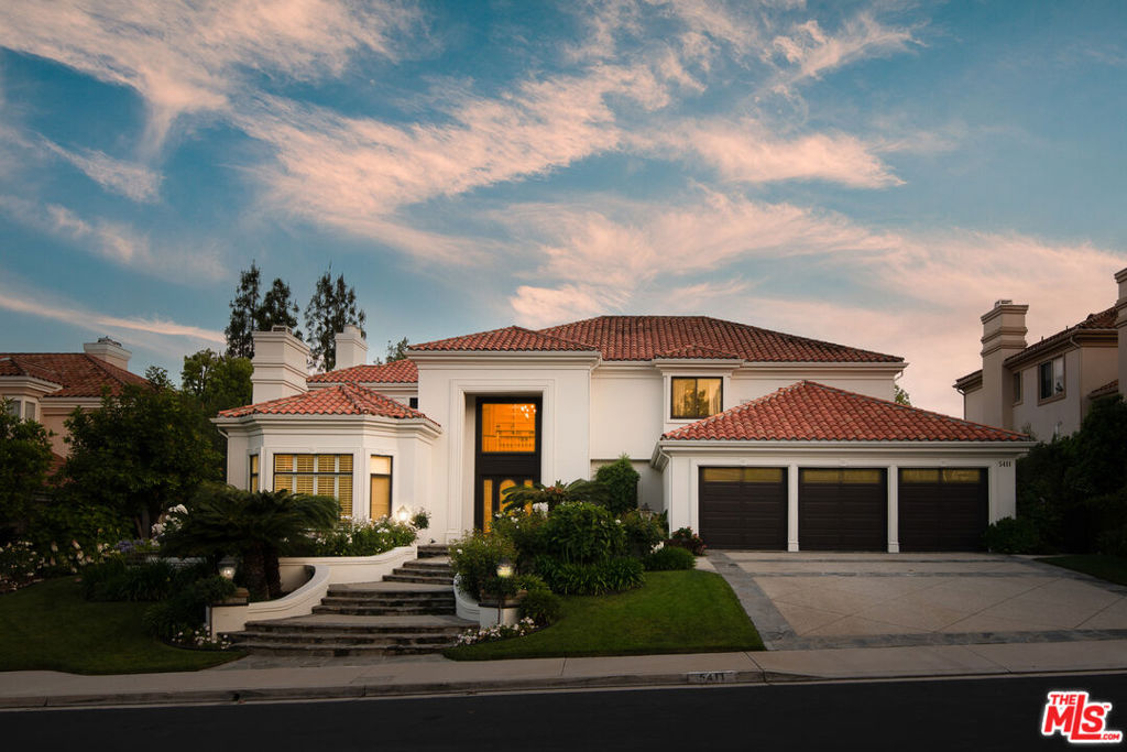Step into timeless elegance in this spectacularly reimagined Mountain View Estates residence, where classic architectural charm meets refined, modern luxury. Recently updated with meticulous attention to detail, this home offers a fresh, sophisticated aesthetic and a host of newly added features that elevate its appeal. A grand entry with soaring ceilings, dramatic new designer lighting, and stunning newer oak hardwood flooring welcomes you. The spacious step-down living room showcases a coffered ceiling, statement fireplace, and seamless flow into the formal entertaining spaces. The inviting family room boasts a second fireplace, custom built-ins, and French doors that open to the lush backyard oasis, creating a seamless indoor-outdoor lifestyle. The heart of the home is the completely reimagined chef's kitchen, now featuring sleek new countertops, new chevron pattern flooring, a stylish extended island bar perfect for casual gatherings, striking backsplash, and a full suite of top-tier stainless steel appliances including a wine refrigerator. Enhanced with a walk-in pantry, butler's pantry, and sunlit breakfast area, this kitchen is both high-functioning and beautiful. The main level includes a well-appointed guest suite with access to a newly renovated bathroom featuring a luxurious steam shower and direct entry to the pool area perfect for resort-style living. Upstairs, the expansive Primary Suite is a serene retreat with vaulted tray ceilings, fireplace, dual walk-in closets, and a peaceful lounge area. The dual spa-inspired bathrooms are completely updated: one offers a steam shower, the other a freestanding soaking tub and separate glass-enclosed shower, each adorned with refined designer finishes. Four additional bedrooms and three newly remodeled bathrooms complete the upper level. Outside, the backyard is an entertainer's paradise with covered patios equipped with built-in heaters and fans, a raised lounge with TV and fireplace, and a state-of-the-art outdoor kitchen featuring a Lynx stainless steel BBQ. Newly re-plastered pool with light pebble tec finish and recently added hardscape. The stunning grounds include lush mature landscaping, a firepit with built-in stone seating, pool, spa, and sports court, an ideal setting for luxurious relaxation and entertaining. Even the garage has been upgraded with pristine new epoxy flooring, reflecting the care and attention to every corner of this home. A true gem in Mountain View Estates in beautiful Calabasas.