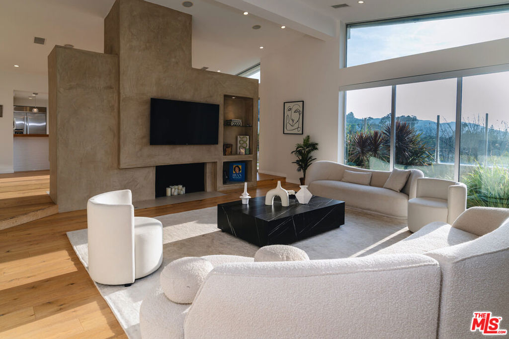 Fully remodeled in 2016, this stunning 5-bedroom, 4.5-bathroom home in prime Sherman Oaks blends modern luxury with smart living. Flooded with natural light, the open-concept layout features soaring high ceilings, a spacious living room, and an entertainer's dream kitchen with top-of-the-line appliances, sleek cabinetry, and designer finishes. The backyard offers the perfect space for relaxing or hosting, complete with lush landscaping and room to entertain. Packed with high-end amenities, this smart home includes a full HVAC system, integrated security cameras with facial recognition, smart lighting, and a cutting-edge automation system for seamless living. Located on a quiet street in a highly desirable neighborhood, this turnkey home delivers comfort, style, and next-level convenience. View endless sunsets in your large master suite which has a walk-in closet and spa-like bath featuring dual sinks, soaker tub and steam shower. Centrally located in the hills of Sherman Oaks with easy access to all of LA's top attractions. Walk into the backyard and drift away in the endless mountain views! Located in the Roscomare School district.