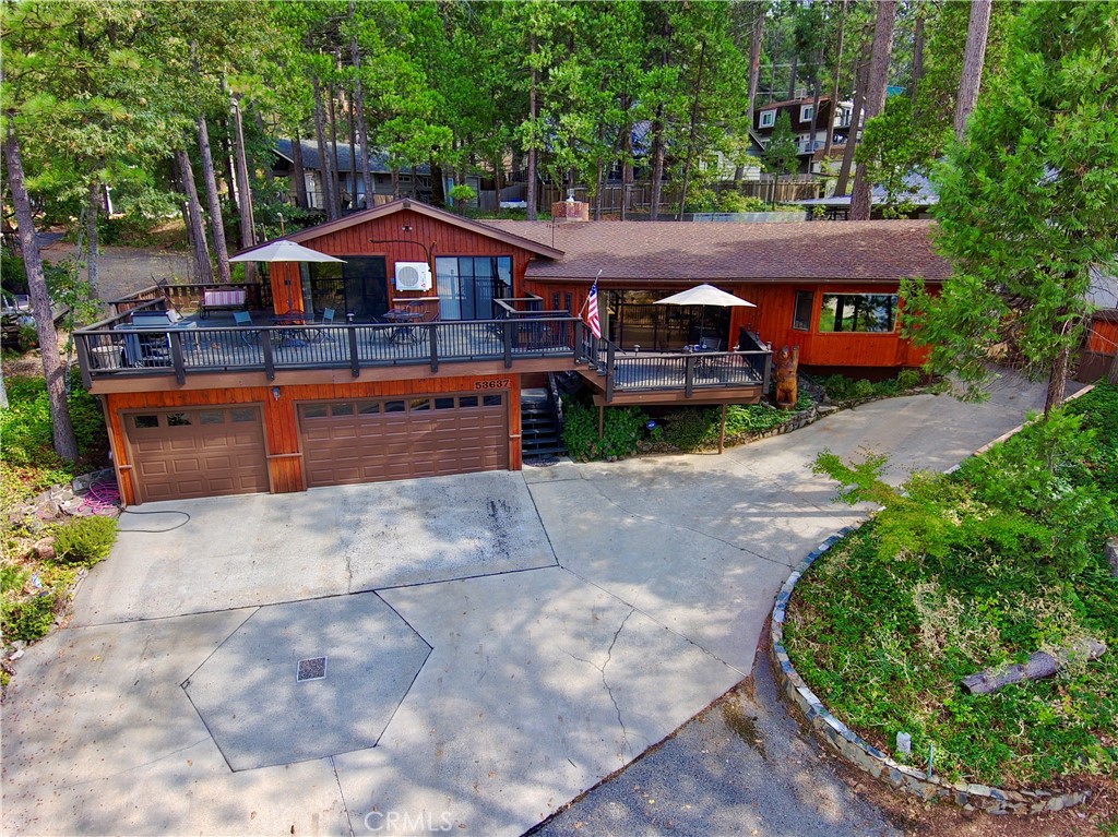 Wonderful Bass Lake Cabin with lake views and boat slip across the street at Acorn Dock! This home is a vacation rental and has real lake-mountain charm! Great room has rock fireplace (gas), wood beam trusses, show board ceilings, wood slab wet bar, pool table area, kitchen area has breakfast bar, huge lake view deck for bbq's & outdoor entertainment! Master bedroom and one of the guest rooms has deck access with lake views! House has well distributed mini-splits for comfort! The garage is super sized with shop area! There is also an easement to the back of the property with room to park the boat! Just down the street from The Pines Village and 30 minutes north to the 41 entrance to Yosemite National Park entrance and 30 minutes south to Chukchansi Gold Resort & Casino. Most furnishings included. Make your appointment to see this one now!