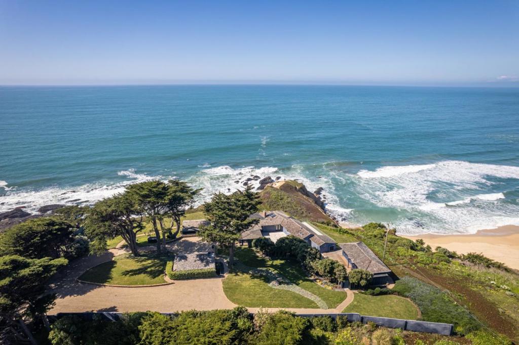 There is only ONE home on the entire coast that has this view, and its this one ! This is a once in a lifetime opportunity to own this family legacy compound. The compound is made up of the main home and 3 additional buildings. The main home is 4 bedrooms and 3.5 bathrooms and has been tastefully remodeled, each additional building is a single bedroom and bath, one with a small kitchenette and all with exceptional ocean views. A beautiful stone drive and pathway lead to an enclosed courtyard and an impressive entry , all while taking in the sweeping views of Montara Beach, the mountains and devils slide. Expansive decks with a solid copper hot tub, 2 fire pits and a green rolling lawn await your family and guests. The property is made up of 3 parcels and is gated for your privacy. Truly, a one of a kind property and a once in a lifetime opportunity to own this stunning piece of property. Square footage of home(s) and lot are approximate.