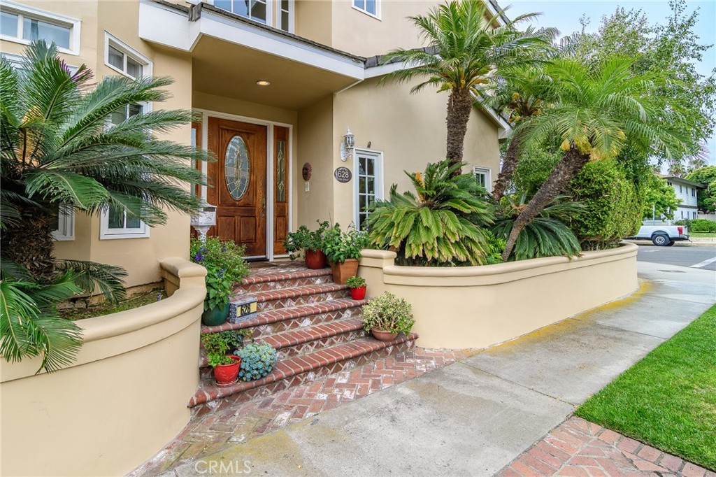 Now available for lease, this rare Downtown Huntington Beach gem offers the ultimate in coastal comfort and flexibility. Just steps from the sand and walking distance to Main Street and Pacific City, this home is perfectly situated for those seeking a vibrant beach-close lifestyle. Set on an oversized 4,312 square foot corner lot, this expansive residence offers over 3,700 square feet of beautifully designed living space—making it one of the largest homes in the area. The flexible layout features 4 generously sized bedrooms, each with its own en-suite bathroom, plus a private office on the second floor—ideal for remote work or a quiet retreat. The remodeled kitchen boasts extra-thick countertops and opens to a cozy family room, creating the perfect space for casual gatherings. The first floor also features soaring ceilings that bring in an abundance of natural light, a formal living room with fireplace and wet bar, and an elegant dining room. The third-level primary suite is a private haven with its own sunlit balcony—perfect for morning coffee or evening relaxation. With premium features, unmatched size, and a location that can’t be beat, this is one of the best values available for lease in Downtown Huntington Beach.