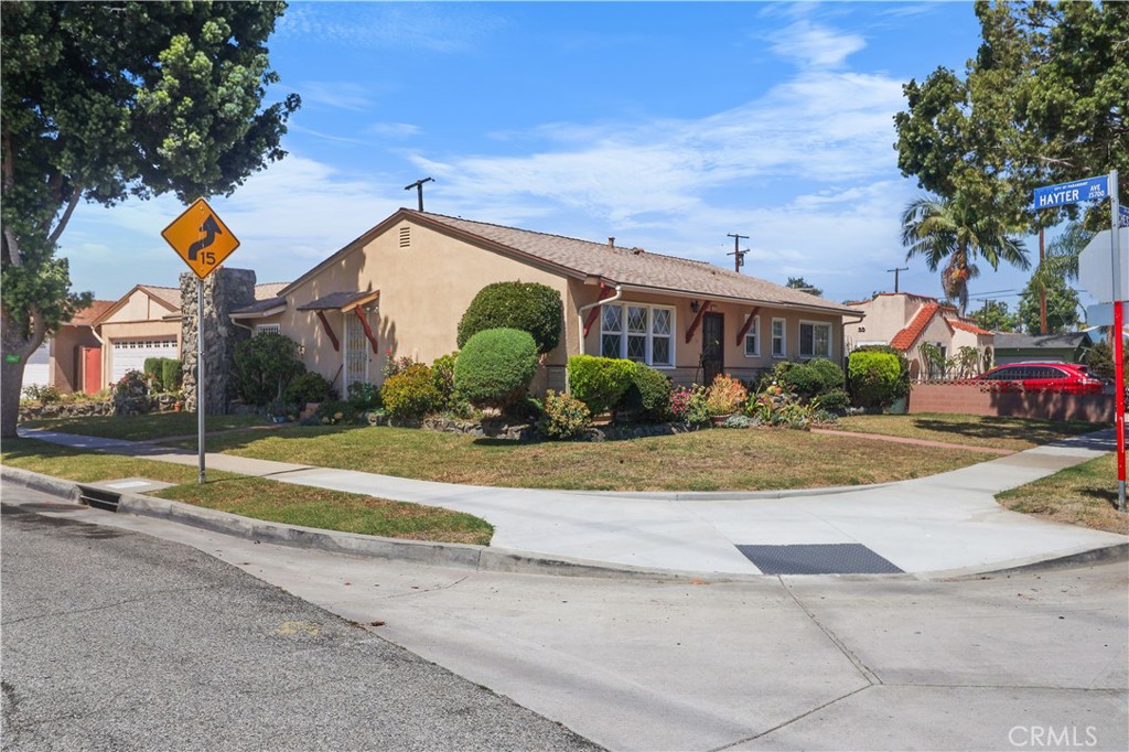 Presenting a spacious single family home awaiting to be remodeled with your own personal modern touches and make shine like a diamond! The home features a big bright Living Room, a Formal Dining Area and a Breakfast Nook adjacent to the Kitchen that has a window that looks out to the great Family Room with a cozy rock raised fireplace and lots of glass windows that allow natural light to shine through including the glass door that leads out to the backyard where fruit trees like persimmon and guava and plants surround. The Primary Bedroom has an ensuite bathroom and big closet space. The 2 Secondary Bedrooms are good size next to the hallway Full Bathroom. The enclosed Laundry area is adjacent to the Kitchen which makes it ideal to convert into a Walk-In Pantry and move the laundry to the 2 Car Attached Garage with direct access to the home, auto opener and plenty storage spaces. The corner & bigger lot size allows more privacy and the potential to expand and build-up for growing and multi-generational family. Good location in one of Paramount best neighborhood within close proximity to schools, parks, markets, shops and the freeways. Standard Trust Sale. Sold As-Is!