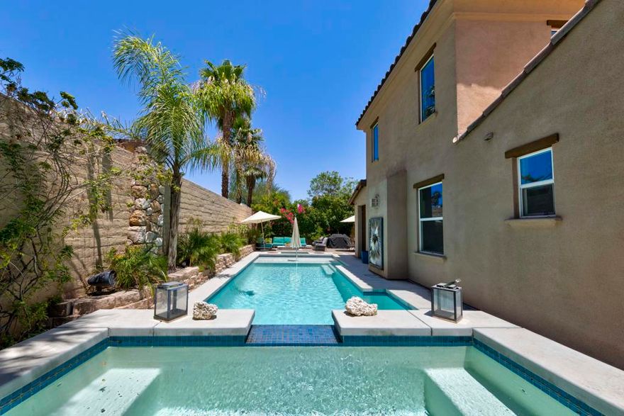 Tucked inside the gates of Village Traditions, this rare stand-alone home captures the Palm Springs lifestyle - modern, effortless, and unforgettable. Just a short stroll to all that downtown Palm Springs has to offer such as boutique shopping, acclaimed dining, and vibrant entertainment. It's the perfect blend of convenience and retreat. Perfectly positioned on an oversized corner lot, it offers privacy, panoramic mountain views, and a sparkling saltwater pool and spa. Inside, you'll find a thoughtfully designed 3BR/3BA layout with dual primary suites (one upstairs, one down), airy vaulted ceilings, and seamless indoor-outdoor flow. The upstairs loft provides flexible space for a gym, office, or cozy lounge. The kitchen is sleek and sophisticated with quartz counters and stainless appliances, while owned solar, a soft water system, and energy-efficient windows keep life comfortable and low-maintenance. Outside, enjoy smart pool controls, Sonos sound, and a private dog run. HOA covers internet, water, and trash. A two-car garage and guest parking complete this picture of contemporary Palm Springs living.
