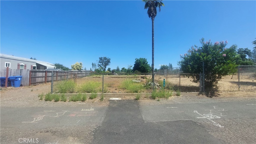 This fairly flat .11 acre lot will accommodate a one bedroom home or single wide mobile home. Good location not far off one of the main arteries through Paradise named the Skyway. This lot is in close proximity to restaurants, shopping, Terry Ashe Park and Starbucks. Three sides of the property have serviceable fencing and one side needs some new fencing and repair to the existing fencing. The Paradise Irrigation District (PID) advises the water account has an INACTIVE status. The PID requires a District Backflow Device to be installed, which is needed for the property. There are three fees required to activate the account. (1) Reconnect Capacity Fee, (2) Reconnection Fee and (3) Meter Installation/Backflow Device Installation fee. Currently the total of the three fees to activate the water account is $4,940 until July 1, 2025. On 07/01/2025 the Reconnect Capacity Fee will increase to $4,350. The total to Activate the water account after July 1, 2025 will be $6,390 and will stay the same from July 1, 2025 to July 1, 2026. On July 1, 2026 the Reconnect Capacity Fee goes to $5,800 and on July 1, 2027 the Reconnect Capacity Fee goes to $7,251. The existing septic system has not been evaluated by the Town of Paradise Building Resiliency Center Septic System Specialist. Most likely a new septic system will be needed.