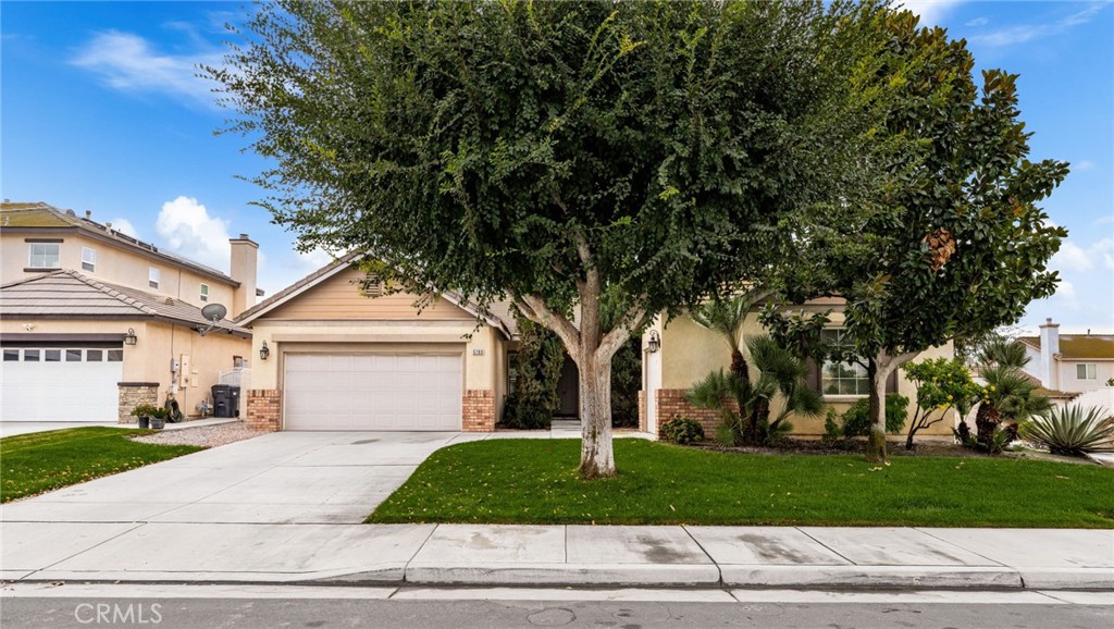True pride of ownership 3-bedroom, 2-bath single level home with a dedicated office and an inviting front porch, built in 2004 and located on a large corner lot. Home boasts an inviting open floor plan, perfect for entertaining. The bright kitchen features an island, an eat-in dining area and a number of cabinets for ample storage and seamlessly flows into the family room, featuring a fireplace and a slider that opens to a cozy patio and private backyard. The spacious living room is enhanced by stylish cutouts that provide a view into the family room, creating a bright and connected atmosphere. The Formal Dining Room is located just off the living room with a window that looks out to the front patio. The Office is conveniently located just off entry and allows for quiet productivity away from the main living space with the potential to be converted into a fourth bedroom. Retreat to the luxurious master bedroom suite, complete with a spa-inspired bathroom featuring a walk-in shower, a relaxing soaker bathtub, dual vanity sinks, a private toilet room and a generously sized walk-in closet. The hallway bathroom also includes dual vanity sinks with bathtub shower combination. There are two other nice size bedrooms down the hall from the master bedroom, one with a window looking out to the front yard. Features include beautiful hardwood floors throughout most of the home, recessed lighting, ceiling fans, dual pane windows and a separate laundry room (included are newer front-loader washer and dryer). The private backyard is designed for ease, with an outdoor patio that is ready for entertaining and requires minimal upkeep. The property includes a two-car garage at the front and an additional one-car garage at the side providing ample parking and storage. Convenient location, in close proximity to shopping, restaurants and freeways(15, 60 & 91)