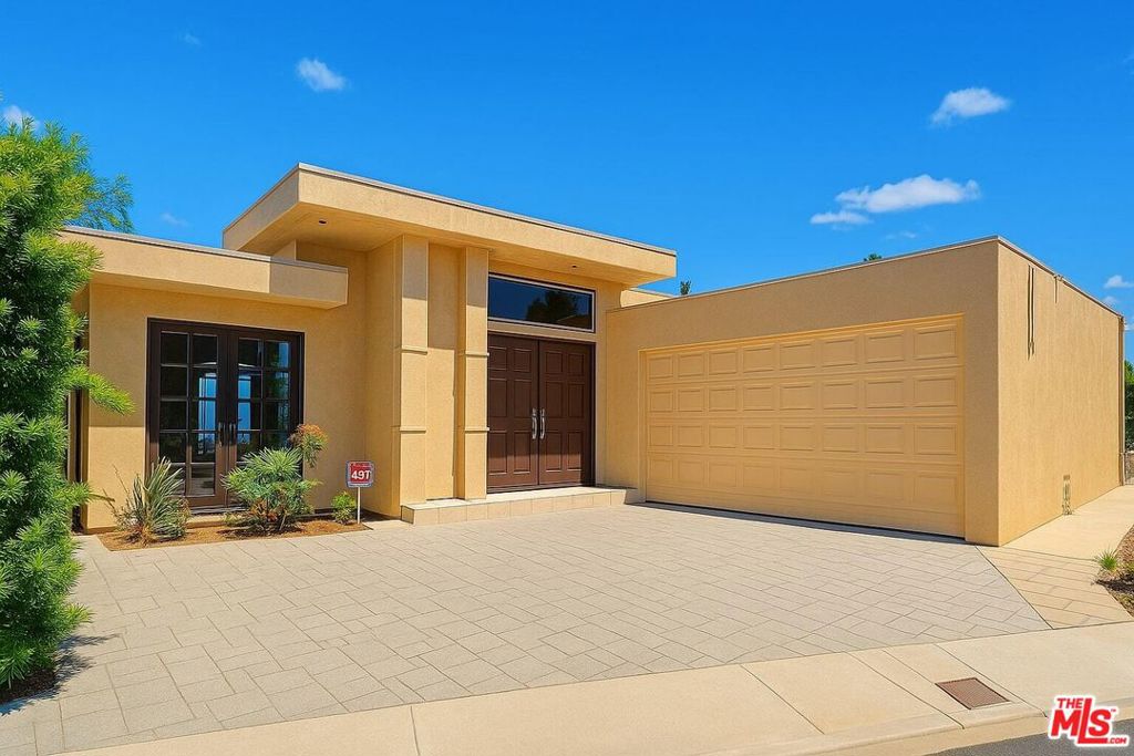 Stunning home with spectacular panoramic views from most rooms! Offering 2,311 sq. ft., this 3-bedroom, 2.5-bath residence combines comfort and elegance. The bright and spacious living room features a cozy fireplace. The kitchen is equipped with granite countertops, abundant cabinetry, and stainless steel appliances, a good sized dining area and a breakfast area. The third bedroom is customized with an oak library. Large patio with exposure to panoramic views. Large sized garage. Tucked away in a quiet, secluded cul-de-sac, yet conveniently close to the 405 and 101 Freeways, Mulholland Drive, and Beverly Hills, this home truly offers the best of both privacy and accessibility.