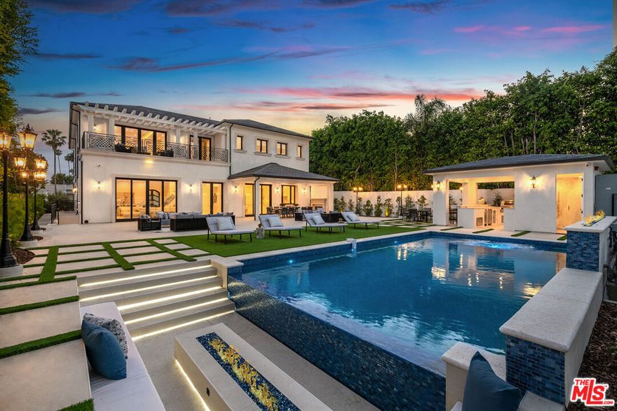 This New Construction Beverly Hills estate embodies the perfect blend of modern sophistication and luxury set on an expansive 14,949 sq ft lot in the heart of the prestigious Flats. Behind the gated entrance you are greeted by a 2-story foyer with a dramatic staircase and custom skylight. 6 bedrooms, 12 bathrooms, a theatre accommodating 15 people, an elevator, and designer-done interiors with coffered ceilings and custom lighting throughout. The open design gourmet kitchen features top-of-the-line appliances, custom cabinetry, and a walk-in pantry. The Great Room features porcelain floors and Fleetwood Doors opening to the resort style yard complete with outdoor kitchen, fireplace, fire pit, and sparkling pool and spa. The home offers a climate-controlled wine cellar, a steam room, and a game room.  The expansive primary suite features a balcony, fireplace, and beautiful bathroom. Huge walk-in closet with the finest cabinetry complete with clothing steam units. This prime Beverly Hills location is steps from world-class dining, shopping, and top-rated schools. This estate isn't just a residence-it's a masterpiece of refined living, where timeless elegance meets modern comfort.