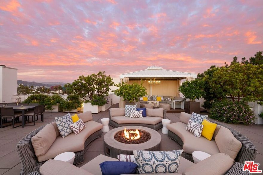 Beverly Hills Penthouse with Private Rooftop Oasis! Indulge in the pinnacle of Beverly Hills luxury on Palm Drive, where this one-of-a-kind penthouse retreat offers over 2,000 sq ft of open-air living space and spectacular 360-degree views of Los Angeles. From Beverly Hills and Century City to the Hollywood Hills, Bird Streets, and Griffith Park Observatory, every sunset and skyline moment is yours to savor. With direct elevator access to both the penthouse and rooftop, this residence ensures privacy, sophistication, and ease at every turn. The rooftop "living room in the sky" is designed for unforgettable entertaining, featuring manicured gardens, fruit trees, an outdoor spa, cabana dining, fire pit, and a full gourmet kitchen with expansive barbecue area. Inside, the 3-bedroom, 3.5-bath penthouse combines elegance with modern convenience: Expansive windows and a massive sliding door system connect the large balcony and living room for seamless indoor-outdoor living. A spacious great room with open dining and lounge areas anchors the home, complemented by a custom-crafted bar, hardwood floors, wine fridge, and immersive surround sound. The Miele-appointed kitchen features built-in plumbed coffee and filtered water systems, paired with bespoke cabinetry and sleek finishes.  The master suite is flanked by two private bedroom suites, each with its own ensuite bath and closet for exceptional privacy.  A custom-designed walk-in closet enhances the master suite.  An additional bonus space functions as a private office or dressing room. Every detail has been curated for refined comfort: automated drapes, custom-designed closets, glass shelving, and a discreet owner's lobby with singular elevator access. The building provides full-service amenities, including: 24-hour concierge and security, Fitness center and owner's lounge. Three secure side-by-side parking spaces with EV charging, Wine closet and additional garage-level storage.                 Perfectly located in the heart of Beverly Hills, the residence offers the rare luxury of peace and privacy while being just moments from Bristol Farms, and the world-renowned shops and dining of Rodeo Drive. This is not simply a penthouse it is an irreplaceable lifestyle, elevating Beverly Hills living to its highest level.