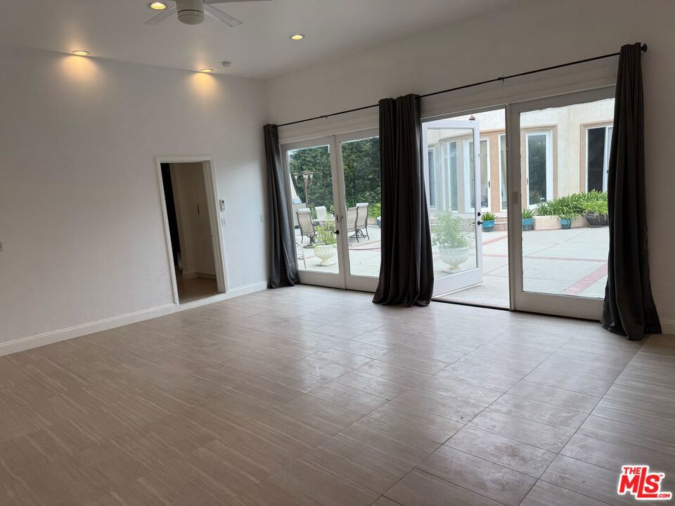Welcome to this beautifully updated ADU in the heart of Brentwood. Offering ~1,000 sqft of modern living space, this 1-bedroom, 1-bath residence blends clean design with comfort. The open-concept layout features a sleek kitchen with state-of-the-art stainless steel appliances, quartz counters, and ample cabinetry, flowing seamlessly into a bright living area with high ceilings, recessed lighting, and oversized sliding doors that open to a private patio. The spacious bedroom provides direct outdoor access, while the stylish bathroom includes a walk-in glass shower and modern finishes. Enjoy indoor-outdoor living with multiple sets of French doors & abundant natural light leading to a large courtyard-style patio. Additional amenities include in-unit washer & dryer, gas stove/oven, climate control, and private entry. Located on a beautiful tree-lined street just moments from San Vicente shops, dining, and all Brentwood has to offer. Don't miss this great opportunity!