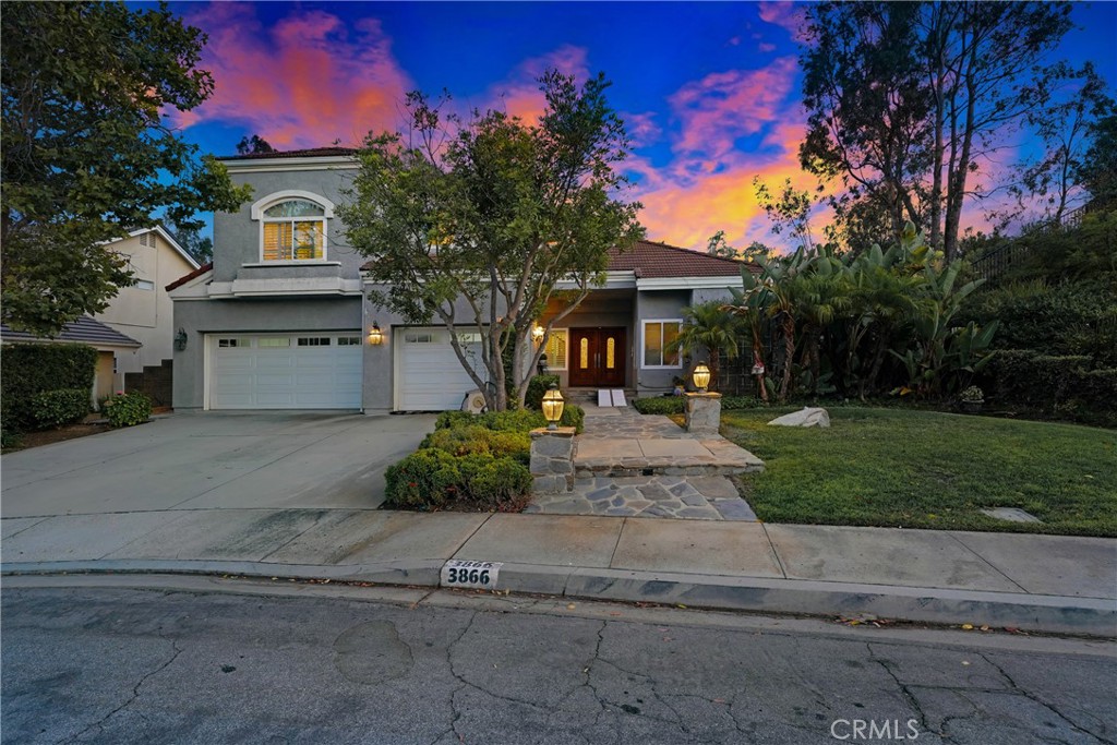 Nestled in the highly sought-after Buttercreek Estates community is a stunning residence that blends luxury, privacy, and functionality. This expansive 5-bedroom, 4.5-bathroom home spans approximately 3,603 square feet and sits on a generous 10,460 sq ft lot at the end of a quiet cul-de-sac, bordered by open space on three sides with only one direct neighbor—offering a rare sense of seclusion and serenity. From the moment you enter through the grand double doors, you're welcomed into a dramatic foyer featuring soaring ceilings, a graceful spiral staircase, and elegant tile flooring. The main level boasts a formal living room with a cozy fireplace, a private ensuite downstairs bedroom, a formal dining room with French doors, and an expansive family room with custom built-ins, recessed lighting, and a second fireplace. The chef’s kitchen is a true centerpiece, featuring granite countertops, a center island with breakfast bar, stainless steel appliances, custom cabinetry, and picturesque views of the backyard oasis. Upstairs, the luxurious primary suite offers a private retreat with a separate sitting area and a spa-inspired bathroom complete with dual vanities, soaking tub, custom cabinetry, and a massive shower equipped with seven shower heads. Three additional bedrooms upstairs provide ample space for family or guests. Outside, the resort-style backyard is an entertainer’s dream, featuring a 600 sq ft covered patio with skylights, ceiling fan, built-in BBQ, outdoor entertainment system, and a sparkling Pebble Tech pool and spa, all surrounded by lush landscaping and tranquil hillside views. Additional highlights include a 3-car garage with built-in storage and custom quiet-close doors, dual-pane windows throughout, and thoughtful upgrades that add style and comfort. Ideally located in a peaceful, established neighborhood with access to top-rated schools, parks, and local amenities, this home is the perfect blend of upscale living and everyday convenience.