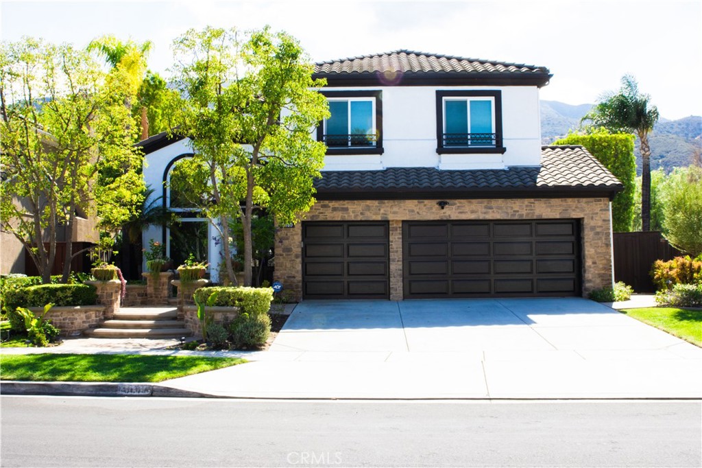 Welcome to this beautifully upgraded 5-bedroom, 3-bathroom home in Corona’s sought-after Sierra Del Oro community. Inside, you’ll find hand-scraped wood and travertine flooring, custom iron railings, and designer bathrooms with Kohler fixtures, frameless glass, and Walker Zanger tile. Built-in surround sound extends through the family room, primary suite, and formal living and dining areas, while outdoor speakers bring rich sound to the backyard. The kitchen features GE Profile built-ins, with a GE smart washer and dryer in the laundry room. Outdoors, a custom BBQ island offers a six-burner range, side burner, and beverage fridge. The Pebble Tec saltwater pool sparkles with an infinity-edge waterfall, and the spa comfortably seats eight. Lush landscaping, hibiscus, succulents, and outdoor lighting create a private retreat. This Sierra Del Oro home combines comfort, convenience, and resort-style living — all with easy access to Orange County commutes.