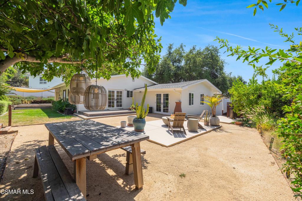 Welcome to this fabulous single story residence, thoughtfully renovated with designer finishes and a bright, open layout. Every detail has been carefully curated, from the French oak engineered hardwood floors to custom lighting and plantation shutters. The chef's kitchen impresses with stainless steel appliances, a professional-grade range, spacious center island with butcher block countertop, and crisp white cabinetry with glass-front accents. It connects seamlessly to the dining and living areas, where French doors lead to the backyard and a striking fireplace creates a cozy focal point. The primary suite is a peaceful retreat with abundant natural light, while the updated bathrooms showcase modern tilework, sleek fixtures, and frameless glass shower doors. Additional features include recessed lighting, raised foundation construction, and a whole-home water filtration system. Step outside to a private backyard oasis designed for entertaining and relaxation. Dine al fresco beneath the shade of mature trees, gather around the fire pit on cool evenings, or enjoy the natural landscaping with room to garden and play. This home offers the perfect combination of sophisticated updates and easy single level living, embodying classic California charm with a modern touch.