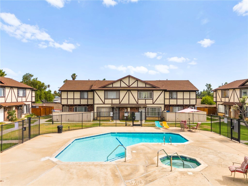 Welcome to this charming 2-bedroom, 2-bathroom townhome in the desirable gated community of Woodland Villas! This two-story home features spacious bedrooms with a Jack and Jill bathroom, beautiful wood floors upstairs, and thoughtful upgrades throughout—including updated lighting, fresh paint, a new water heater, and newer windows. Enjoy the convenience of a full bath on the main level, an attached 2-car garage with washer/dryer hookups, and an additional reserved parking space. The covered patio has been newly upgraded with fresh concrete and offers a private outdoor space that leads directly to the garage. Right outside your front door, you’ll find the community pool—perfect for relaxing or socializing—and you're just minutes from the 60 and 215 freeways, March Air Reserve Base, UCR, shopping, and dining. Comfort, convenience, and location all come together in this move-in-ready gem!