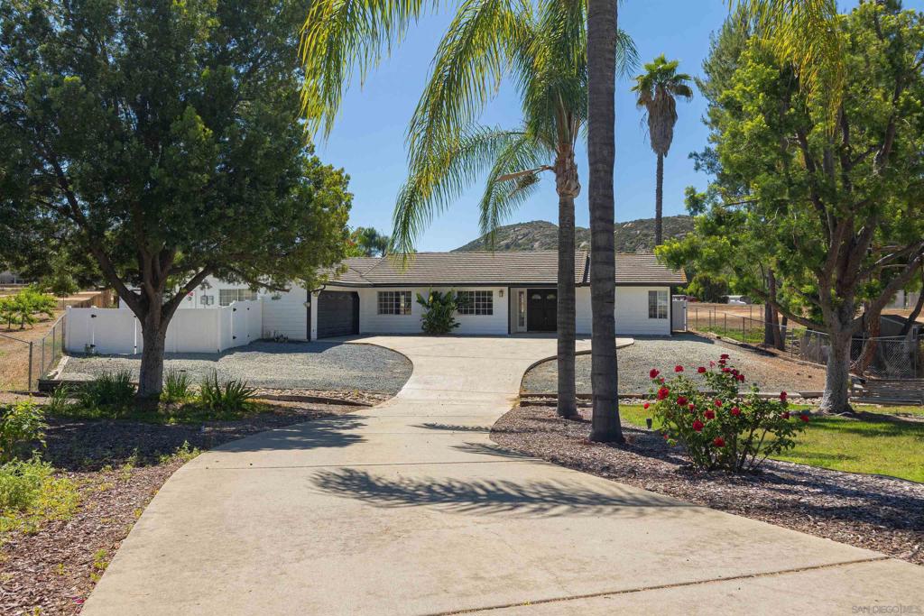 Over $198,000 in Upgrades including a new roof with owned solar, fully remodeled kitchen and bathrooms, new A/C, flooring, paint, and electrical upgrades throughout. Tucked at the end of a long private driveway in a peaceful cul-de-sac, this 5-bedroom, 2-bath single-level ranch-style home offers privacy, mountain views, and no rear neighbors. The backyard opens to protected open space maintained by the San Diego Country Estates Association, where scenic horse trails converge. Ideal for entertaining or relaxing, the backyard features two covered patios, usable flat space, and rear access for RV or boat parking. Inside, enjoy a thoughtful layout perfect for families or multi-generational living. The private primary suite includes a walk-in closet, backyard access, and a luxurious hammered copper soaking tub. On the opposite wing, four additional bedrooms and two separate living rooms provide flexible space for gathering or working from home. The heart of the home is a fully renovated kitchen with quartz countertops, custom cabinets, premium appliances, and designer tile. Both bathrooms have been upgraded, and the home features new flooring throughout, a new A/C system, all-new light switches and outlets, and fresh exterior paint. A new roof and fully owned solar were added in 2018, providing long-term energy efficiency. Additional features include dual-paned windows, an attached two-car garage, and a private well that irrigates the entire landscaped lot. Located within the highly desirable San Diego Country Estates with low HOA fees and access to incredible amenities.
