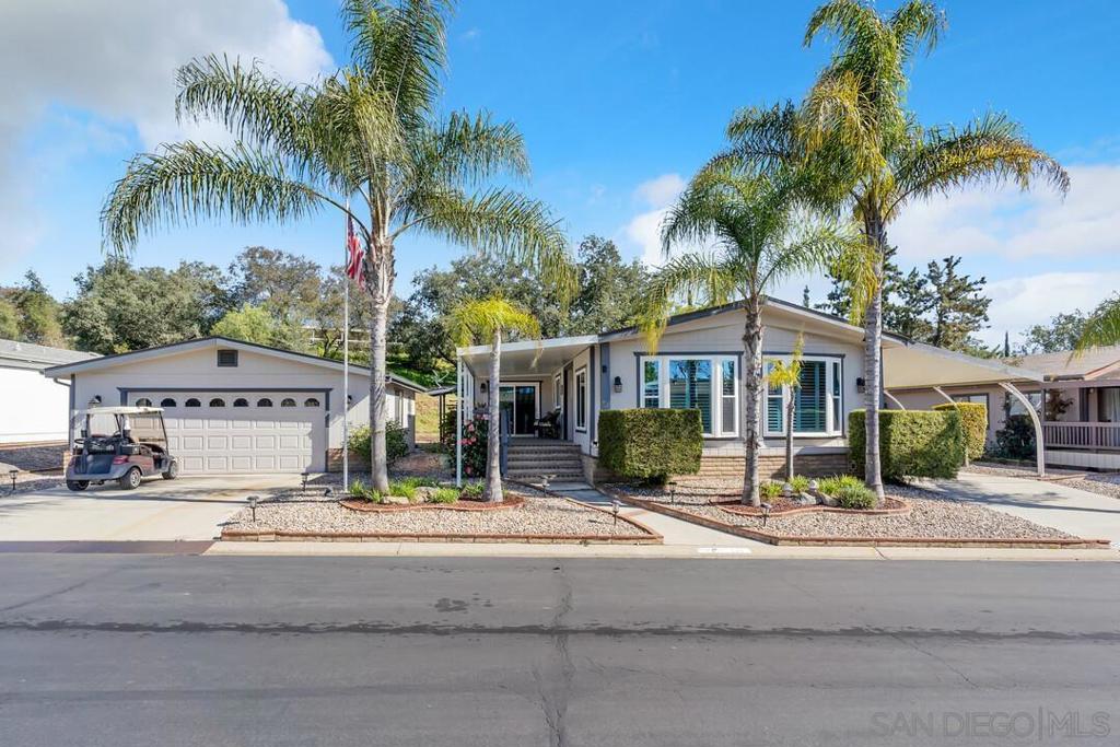 One of the nicest homes in one of the prettiest 55+ Gated Communities in San Diego County. This 2br/2ba manufactured home in Skyline Ranch Country Club boasts almost 1,800 sq.ft. of living space and a huge two-car garage. Owners have spent over $126,000 in improvements including a completely remodeled Kitchen w/thoughtful storage, high-end cabinetry, granite counters, stainless steel sink & appliances & a large walk-in pantry... See Supplement for addition information. Both bathrooms were remodeled featuring "adult-height" custom vanities, low-flow commodes, updated lighting. The Primary bedroom is a good size and offers a huge (11' x 7') walk-in closet w/built-in storage. The 2nd bedroom also has a large walk-in closet and direct access to the 2nd bathroom. A convenient Laundry/Utility room houses the full-size washer/dryer, a utility sink & closet, extra storage cabinets & work station/desk. Easy-care laminate flooring throughout; dual-pane, low-E windows w/Plantation Shutters in the Living Room. Exterior improvements include: Newer roof, newer carport supports & outdoor awning, BBQ Station w/Bar seating, Pergola for additional covered seating. Backyard is tastefully landscaped and offers a private setting, perfect for entertaining. In addition to the 2-Car Garage, there is available off-street parking for five additional vehicles. The Skyline Ranch Country Club community offers FREE golf to all residence on the SCGA Par-60 Course, a lovely Clubhouse, Exercise Room, Pool/Spa, dog park, walking paths and RV Parking. Located near three casinos, Bates Nut Farm and just a short drive to downtown Valley Center; where you will find grocery stores, a post office, a bank, etc. Come see all this home & community have to offer. You won't be disappointed!