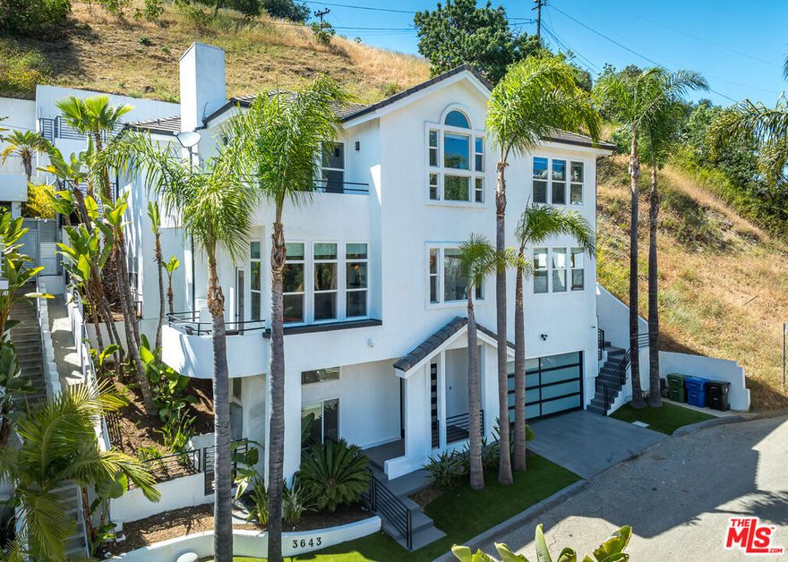 Nestled in the serene hills of Studio City, this modern trilevel masterpiece redefines sophisticated living. Featuring 4 bedrooms and 5 bathrooms, every inch of this home has been thoughtfully curated with high-end finishes and luxurious comfort in mind. Each bedroom boasts its own private en-suite bathroom, offering privacy and convenience for family and guests alike. Step into a chef's dream kitchen, complete with Thermador appliances, oversized refrigerator, built-in coffee maker, and striking Geoluxe countertops. Entertain with ease at the expansive island or in the formal dining room, and showcase your collection in the Elan Vault 340-Bottle Glass Wine Showcase. Soaring 14-foot ceilings, engineered wood flooring, and sleek metal railings set the tone for contemporary elegance. Each bedroom features its own private balcony with sweeping canyon or city views. The primary suite is a tranquil escape with a wraparound balcony and spa-style bath, including an oversized copper soaking tub. Smart home features, a multi-zone A/C system, camera security, and a 2-car garage ensure convenience and peace of mind. The tiered backyard offers a private, elevated retreat perfect for quiet mornings or entertaining under the stars. Located within the boundary map of the highly sought-after Carpenter Community Charter School, and walking distance to the prestigious Harvard-Westlake School, this home is also just minutes from Ventura Blvd's top-rated shopping, and dining. This is a rare opportunity to own a truly exceptional home in one of L.A.'s most desirable neighborhoods.