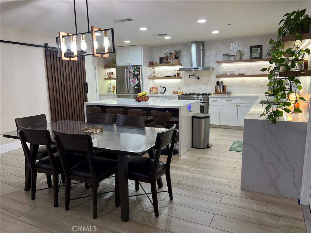 This 2,376 sq. ft. home features 3 bedrooms, 2.5 baths, a spacious loft, and a downstairs bonus room perfect for an office. The show-stopping kitchen was fully remodeled about two years ago with quartz countertops, a full-wall white backsplash, floating wood shelves, gold hardware, stainless steel appliances, and a large waterfall island. Pantry features a stylish wood barn door.
The open floor plan flows from the living room to the dining area and kitchen. Downstairs includes a guest-friendly half bath and French doors leading to a private backyard with an Alumawood patio cover and no rear neighbors.
Upstairs, the primary suite offers a large walk-in closet, dual sinks, and a walk-in shower. Additional highlights include a converted under-stair kids’ playroom, 18 solar panels for energy savings, and plenty of driveway parking.
Located in Monument Park with no HOA, close to parks, schools, and shopping.