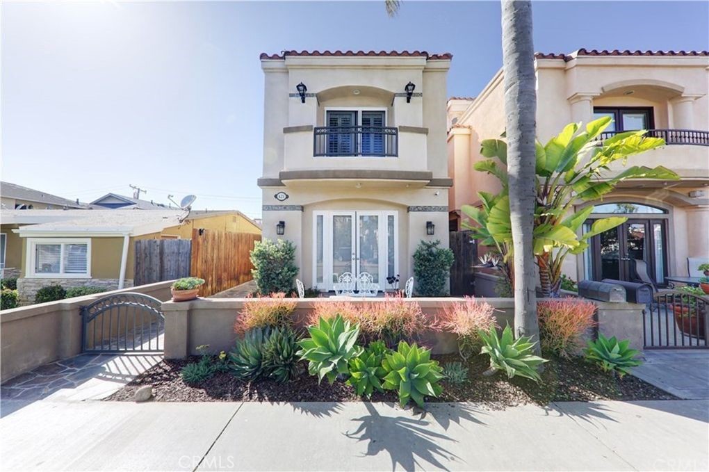 Live the ultimate Downtown Huntington Beach lifestyle just four blocks from the sand! This beautifully maintained Mediterranean-style home offers the perfect blend of charm, comfort, and coastal convenience. With only about 8 of this unique floor plan ever built, this semi-custom, three-story layout is truly a rare find. Inside, you’ll find 3 spacious bedrooms, 3.5 bathrooms, and a versatile third-floor bonus room, ideal for a 4th bedroom, home office, or sunny retreat. The main level features a formal living room with French doors that open to the front patio, a separate dining area, and a light-filled kitchen and family room that seamlessly flows out to a large, private backyard patio, perfect for entertaining or weekend BBQs. Upstairs, the primary suite boasts its own balcony, a cozy raised fireplace, a walk-in closet, and an ensuite bath with a soaking tub and separate shower. Down the hall, two additional bedrooms share a Jack-and-Jill bath, along with a convenient laundry area. On the third floor, you’ll find another full bathroom, access to a sundeck, and the flexible bonus room. This home has been recently refreshed with refinished cabinetry, a tankless water heater, and upgraded luxury vinyl flooring throughout the bedrooms and bonus room, classic wood look with waterproof durability. Additional features include double-pane windows, 3 fireplaces, stainless steel appliances, no carpet, a refrigerator, and a dryer. Enjoy parking for 3 vehicles with a 2-car garage plus an extra spot in front. Located on a quiet, tree-lined street, just blocks from Pacific City, award-winning schools, and downtown shops and dining, close to the action, yet peacefully removed.