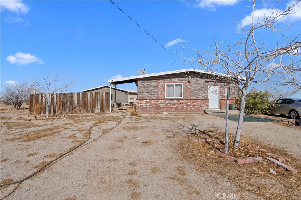 Welcome to this cozy 2 bed, 1 bath vintage retreat fixer, set on nearly 5 acres of open desert landscape. Perfect for those seeking space and serenity, there's plenty of room to bring your toys, animals, or even start your dream homestead.
The inviting living room features a classic brick hearth—ideal for cozy evenings. Enjoy breathtaking desert sunsets and wide-open skies right from your doorstep. This unique property offers endless potential in a peaceful, rural setting. Listing will be SOLD AS IS.