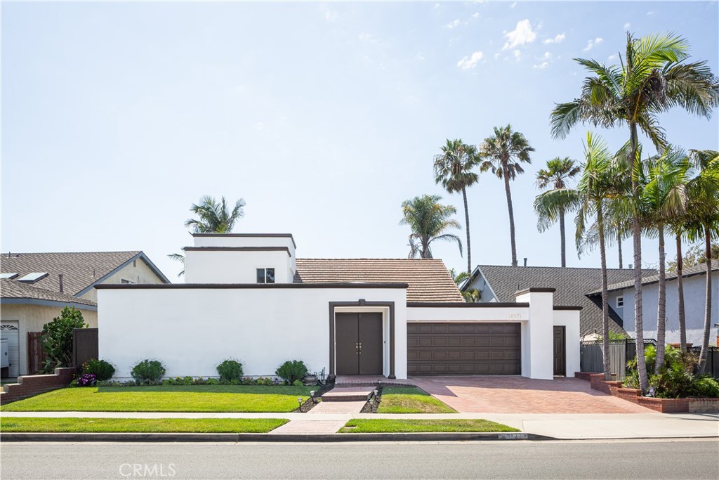 Tucked away in one of Huntington Beach’s best-kept secrets, this beautifully remodeled Huntington Harbor home offers the perfect blend of beachside charm and modern elegance. With a spanning open floor plan on a large and impressive lot, this two-story retreat is designed for comfort, style, and effortless California living. Step inside to discover a thoughtfully reimagined floor plan, featuring 3 spacious bedrooms and 2.5 designer bathrooms. A versatile oversized bonus room on the main level offers endless possibilities—perfect for a home office, media room, or additional living space. The heart of the home is the gourmet kitchen, boasting crisp white cabinetry, gleaming granite countertops, a center island, a cozy breakfast nook, and sleek stainless steel appliances—ideal for everything from casual mornings to lively dinner parties. Vaulted ceilings in the living room create an airy, open ambiance, while large skylights and recessed lighting throughout bathe the home in natural light. Step outside through oversized windows and French doors to your own private tropical oasis. The lush backyard, complete with a spacious concrete patio, is perfect for relaxing, entertaining, or soaking in the Southern California sunshine. When it comes to location, this home is a dream—just a short stroll to the sand, near the world-famous Downtown Huntington Beach and Sunset Beach, as well as parks, top-rated schools, shopping, and dining. This Huntington Harbor treasure is a must-see!