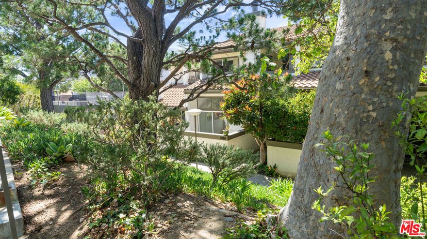 Welcome to this beautifully remodeled and light-filled 1,720 sq ft townhome, ideally located in the desirable Highlands neighborhood of Pacific Palisades. This charming residence features 2 spacious bedrooms and 2.5 elegantly appointed bathrooms. A serene greenbelt walkway leads to the private entrance of this updated home. Step inside to a stunning living room with soaring ceilings, a cozy fireplace, and an adjacent dining area that opens to a tranquil private patioperfect for entertaining or relaxing. The bright and spacious kitchen is a chef's dream, featuring granite countertops, new cabinetry, a center island, stainless steel appliances, and a delightful breakfast nook. The primary suite offers a walk-in closet with custom wood shelving, a luxurious en-suite bathroom with granite and marble finishes, and access to a second private patio. The second bedroom is complemented by a beautifully updated bathroom with quality marble and custom cabinetry. Throughout the home, you'll find rich hardwood flooring accented by tasteful tile, marble, and granite touches. A private staircase leads directly to the attached two-car garage, providing added convenience. Residents of the community enjoy resort-style amenities including tennis courts, a swimming pool, sauna, and fitness center.