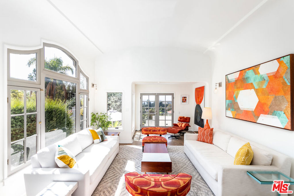 This beautifully renovated and vibrant 3-bedroom, 3-bathroom FURNISHED Spanish-style home in the Hollywood Hills boasts stunning city views and ample outdoor spaces ideal for entertaining! As you enter, you are welcomed by a spacious living room featuring vaulted ceilings and a gorgeous Palladian window, with French doors that open to a large patio equipped with a built-in BBQ and refrigerator, perfect for alfresco dining and gatherings. The chef's kitchen includes a walk-in pantry, an eat-in bar, stainless steel appliances, and a center island, seamlessly connecting to the dining room for entertaining and engaging family moments. On the lower level, the guest bedroom/den/office opens to an outdoor terrace, providing a refreshing space for midday breaks. Upstairs, the primary suite offers views of the Downtown skyline, a generous custom walk-in closet, and an exquisite ensuite bathroom with dual sinks, a spacious shower, and a deep soaking tub. A delightful second bedroom features access to a private covered terrace with sweeping city views, perfect for enjoying morning coffee and meditation. The home is adorned with beautiful hardwood floors throughout, while the fireplace is purely decorative. Located near the iconic Sunset Strip, Bristol Farms, Toi Thai, El Compadre, The Griddle, Runyon Canyon, and much more, this residence provides the perfect blend of tranquil living and vibrant entertaining! This property is not available unfurnished. Tenant representation must make first contact and be present at all showings for representation concessions to be considered.